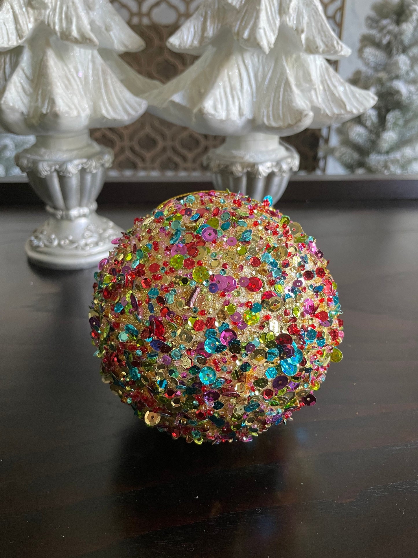 4.5” sequin ball ornament, red main color with multiple secondary colors.