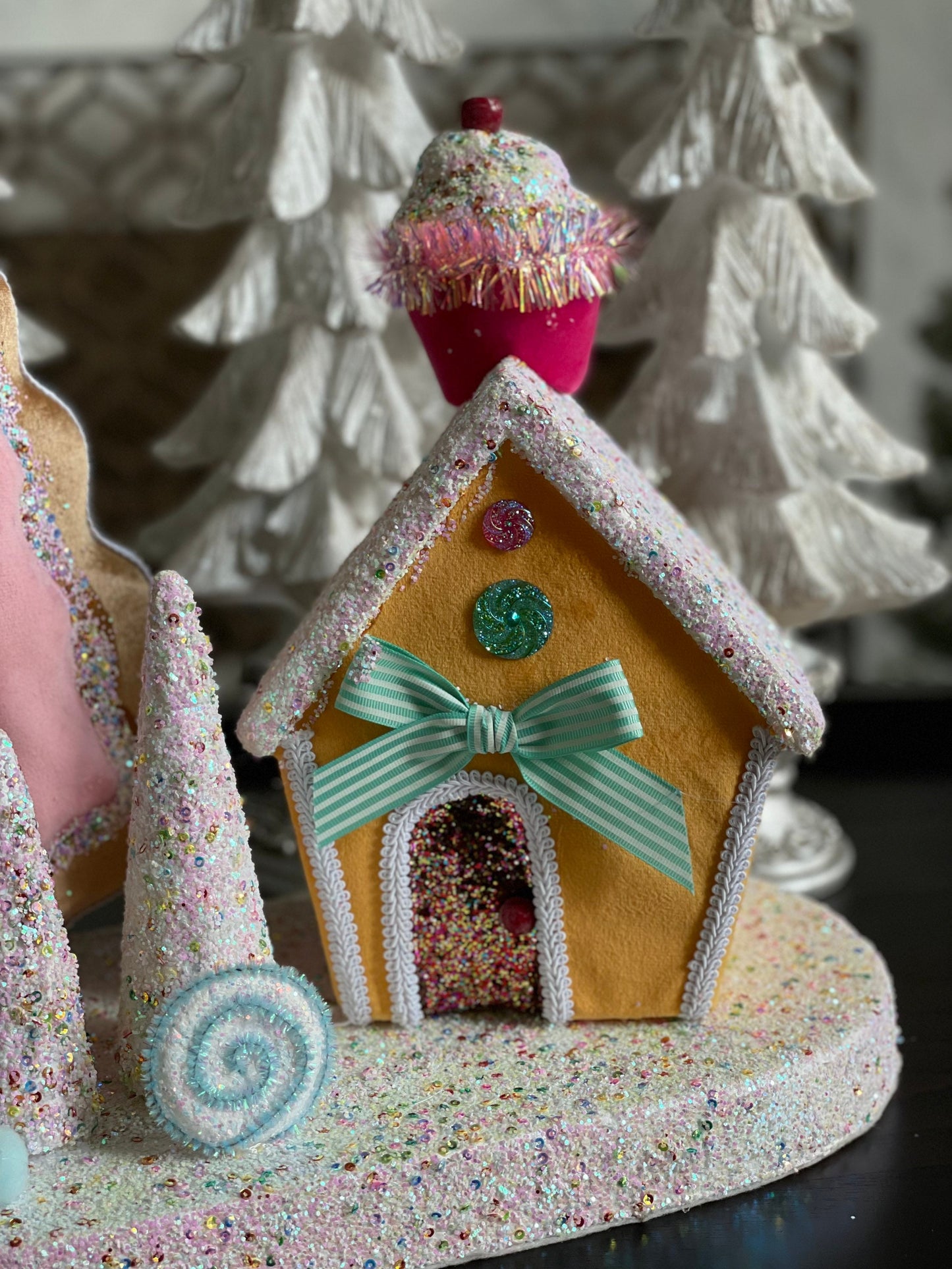 14”Hx 16”W. Candy house with cupcake, candy and trees. One Candy house.