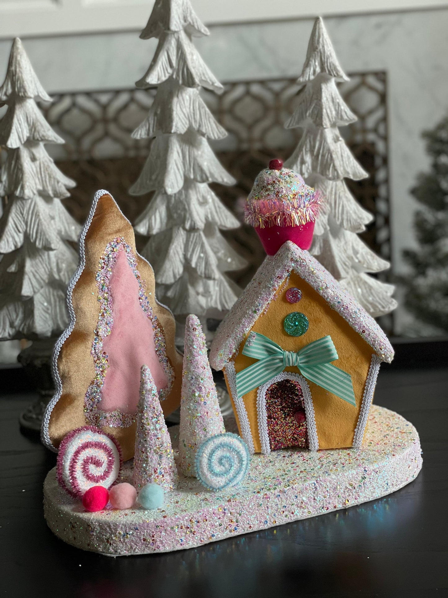 14”Hx 16”W. Candy house with cupcake, candy and trees. One Candy house.
