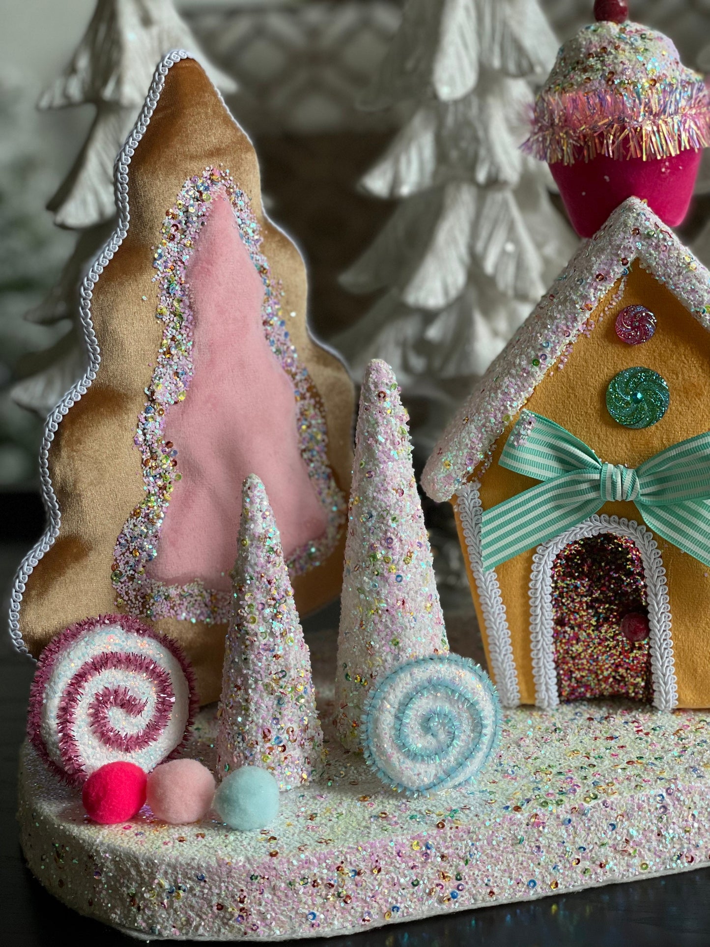 14”Hx 16”W. Candy house with cupcake, candy and trees. One Candy house.
