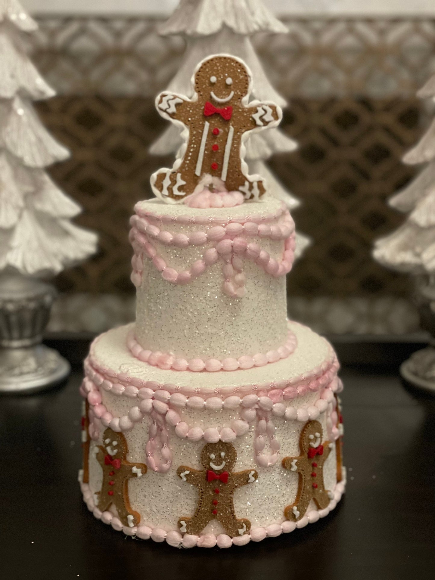 14”h x 8”w gingerbread Christmas icing pink cake.