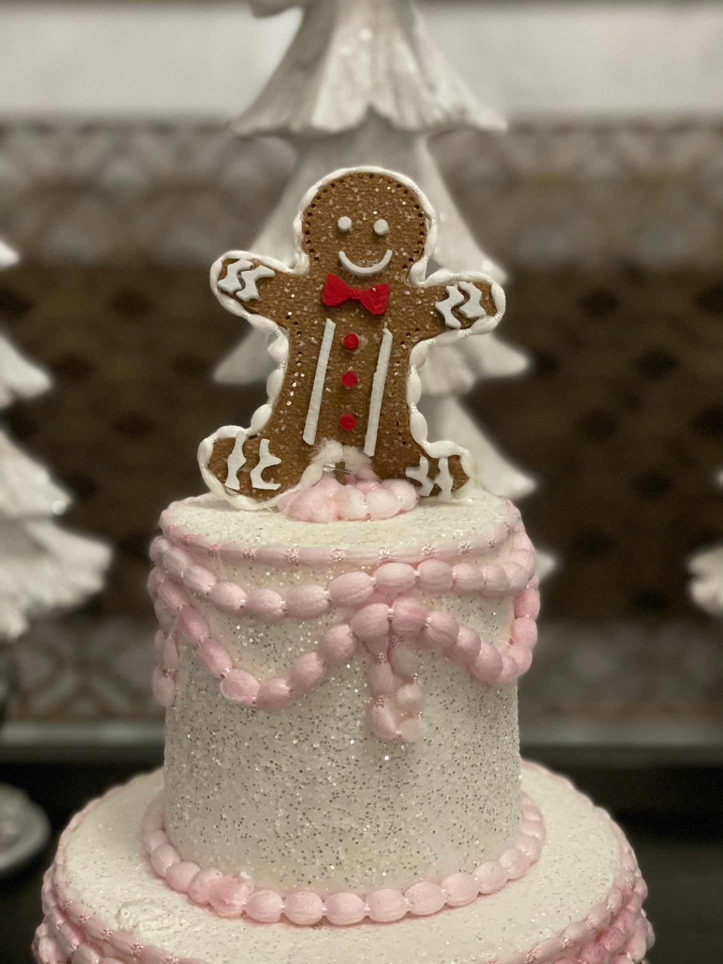 14”h x 8”w gingerbread Christmas icing pink cake.