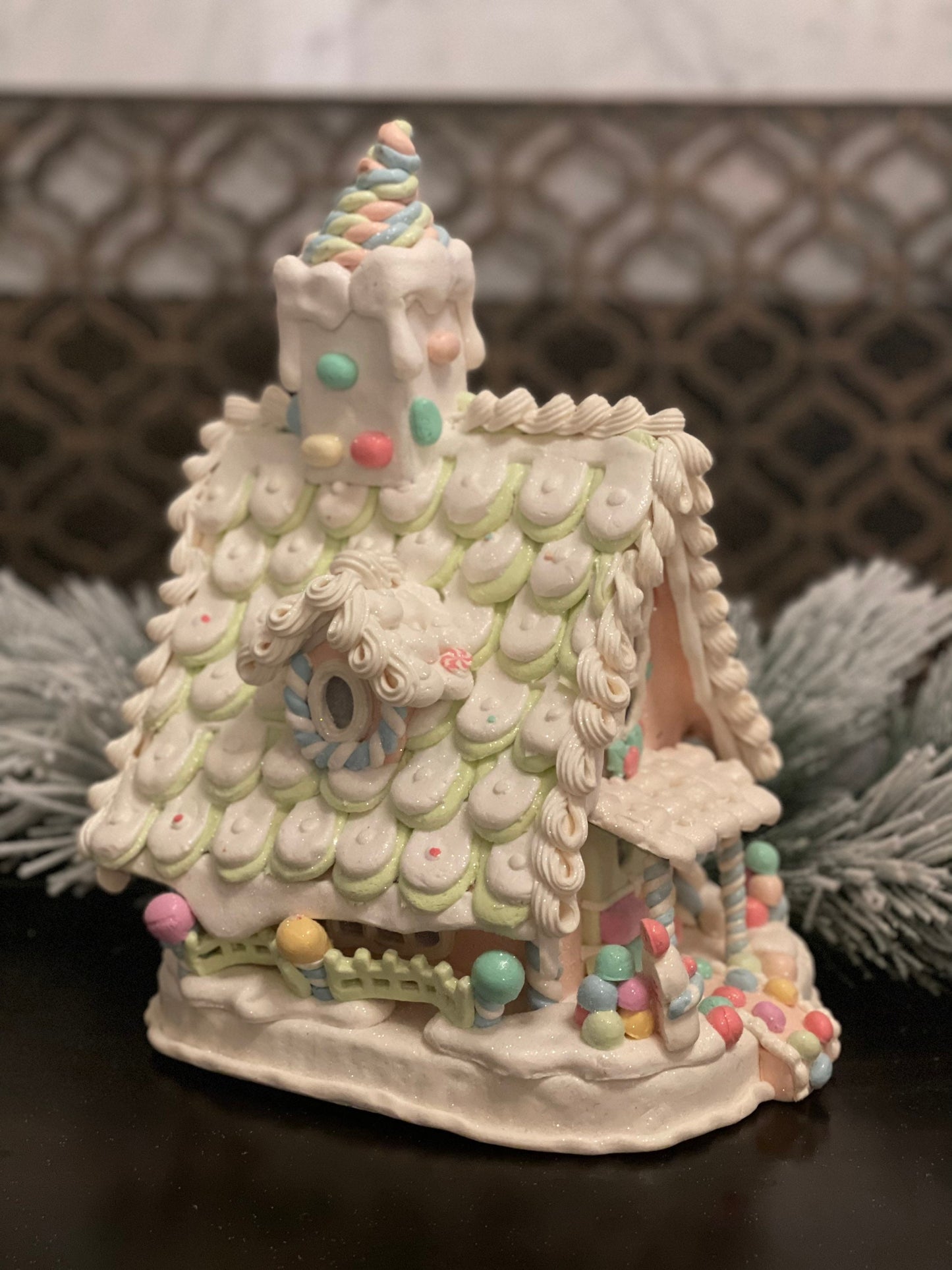 10”L x 13”H x 8.5 W Candy frosted house with snowman. Lighted. Pastel colors.
