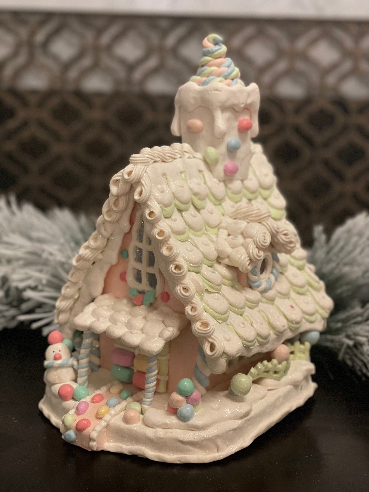 10”L x 13”H x 8.5 W Candy frosted house with snowman. Lighted. Pastel colors.