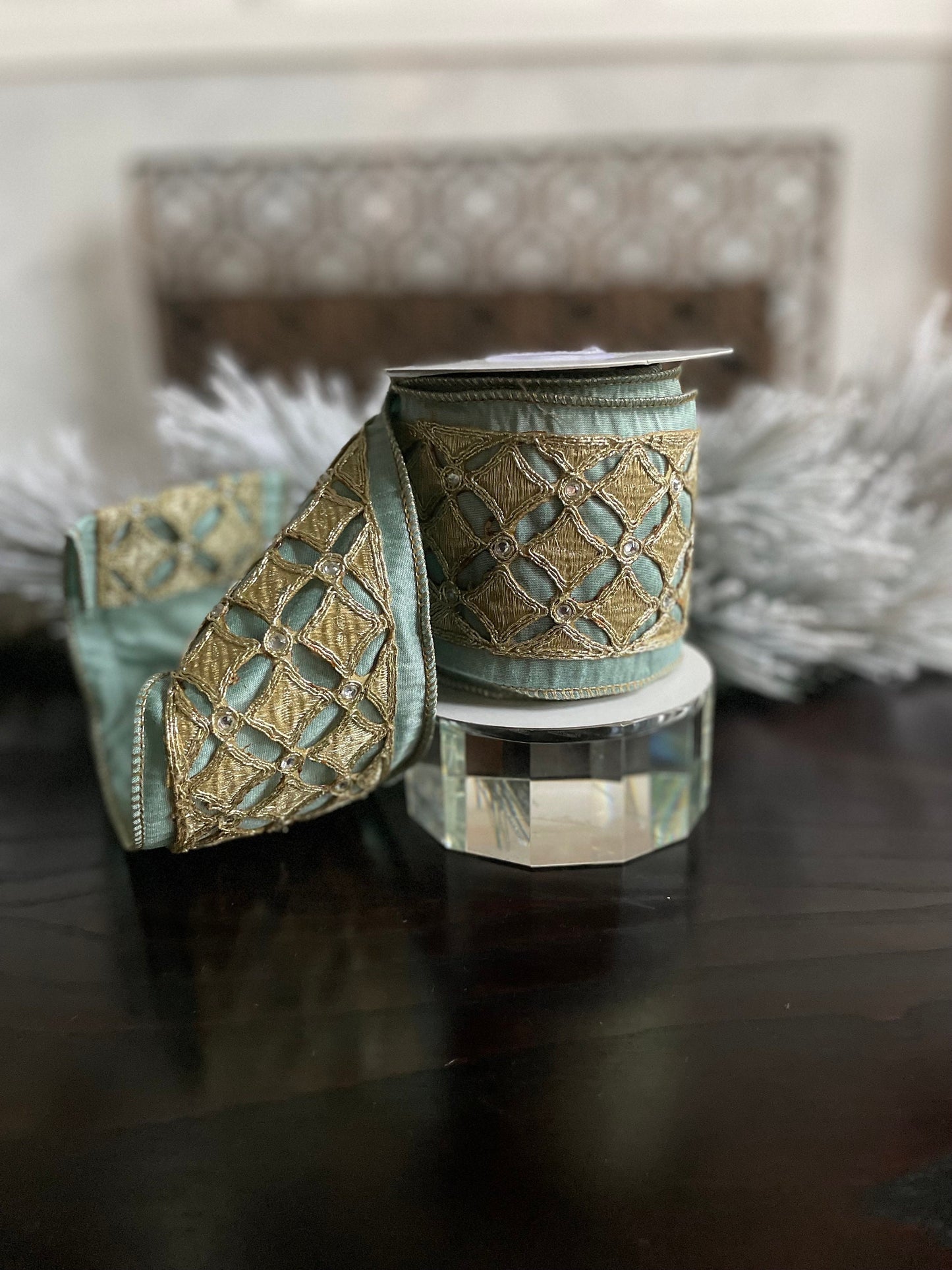 4” x 5 yds. Designer aqua and platinum jeweled diamond dupion ribbon. Aqua and platinum ribbon. Wired. Regency.