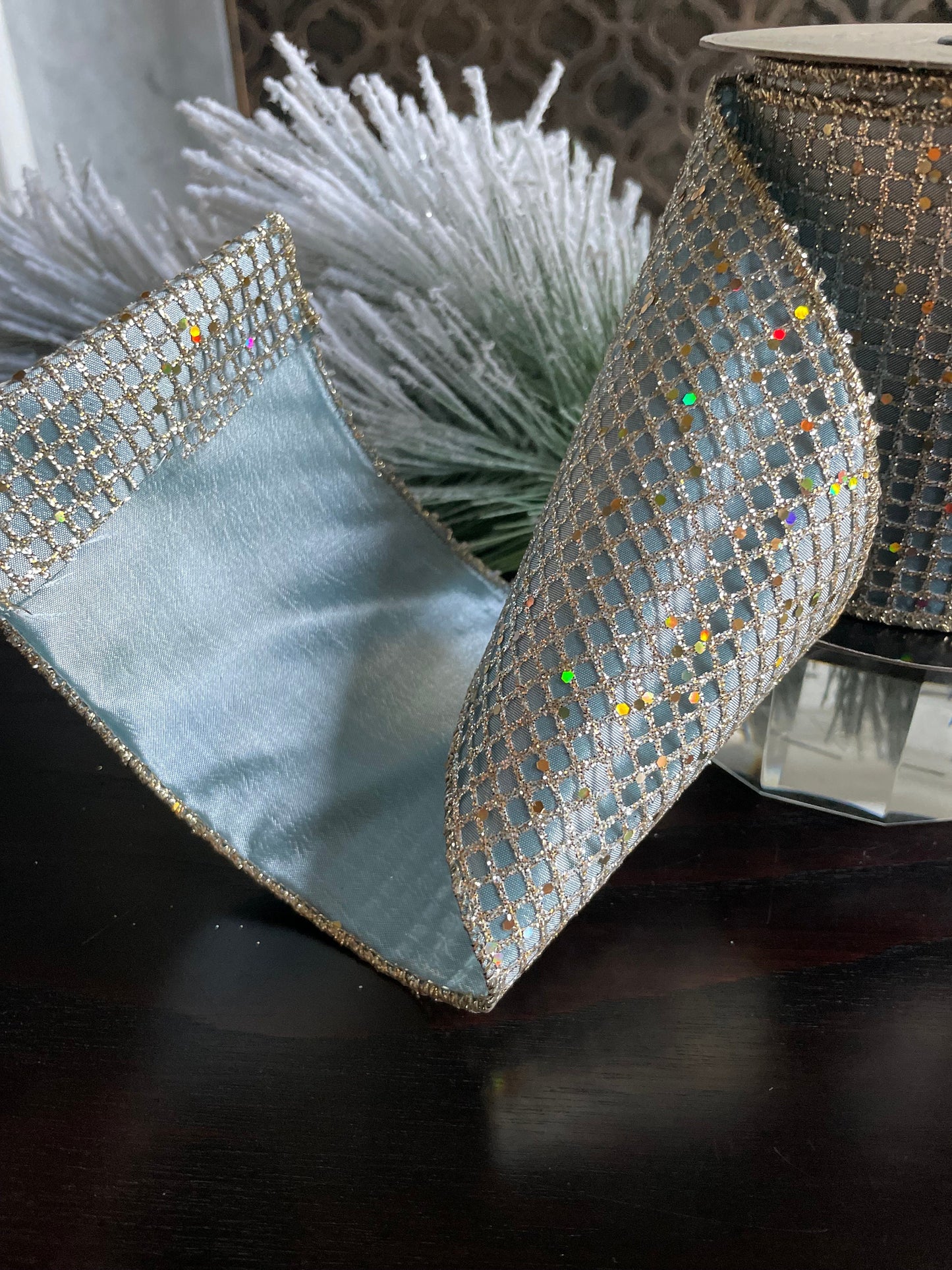 4” x 10 yds. Designer taffeta glitter mesh platinum-blue ribbon. Wired. D. Stevens.