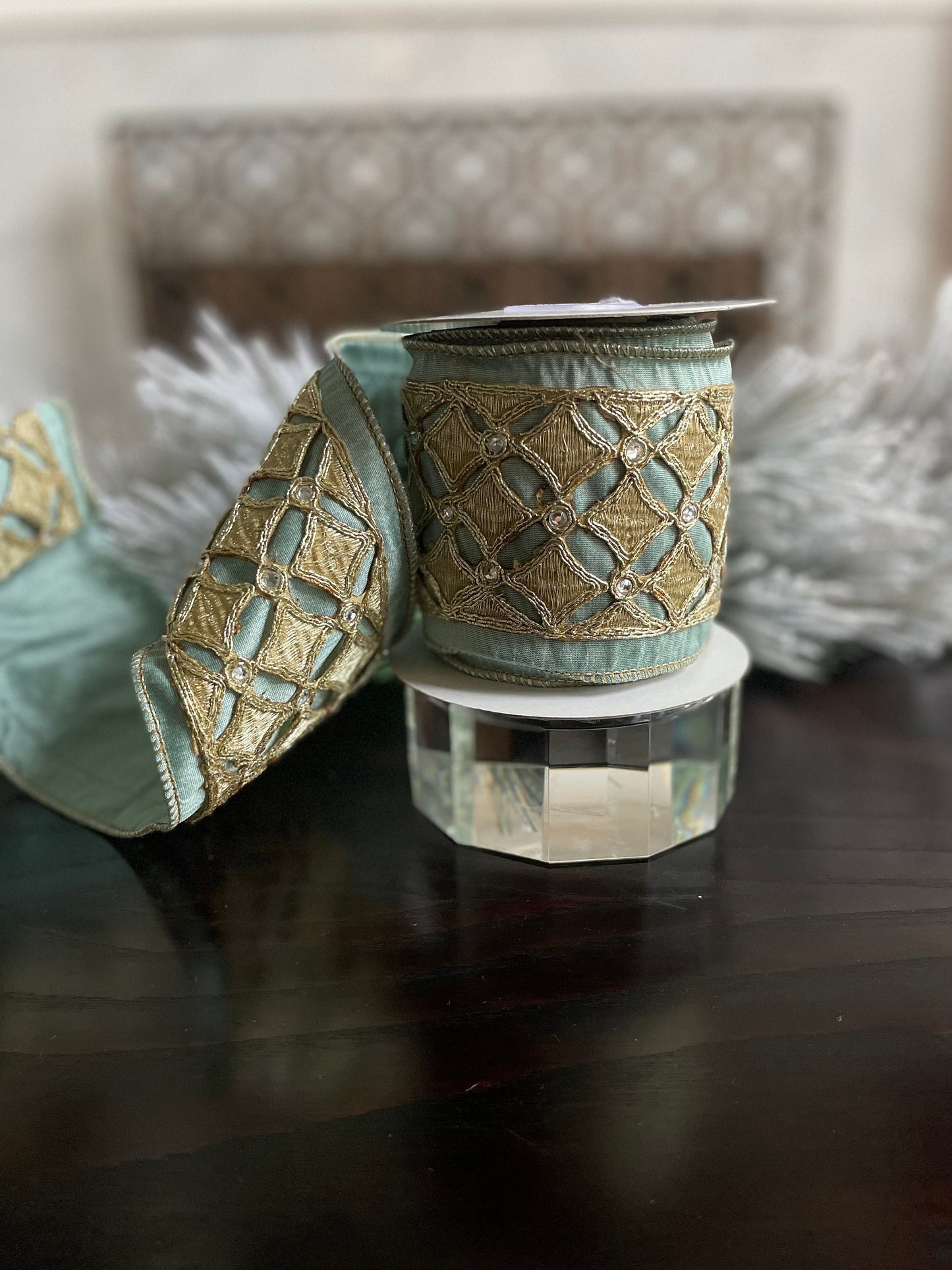 4” x 5 yds. Designer aqua and platinum jeweled diamond dupion ribbon. Aqua and platinum ribbon. Wired. Regency.