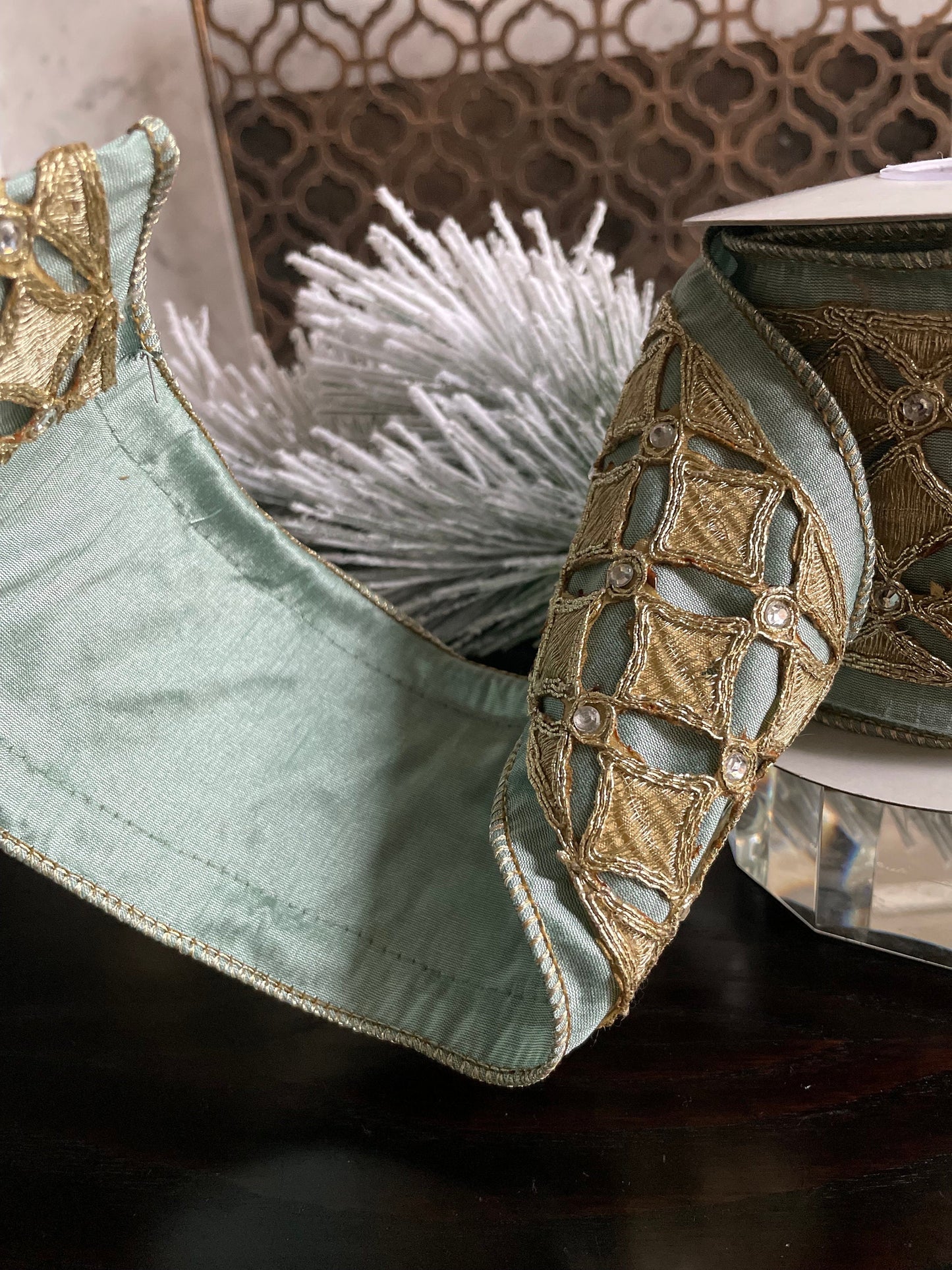 4” x 5 yds. Designer aqua and platinum jeweled diamond dupion ribbon. Aqua and platinum ribbon. Wired. Regency.