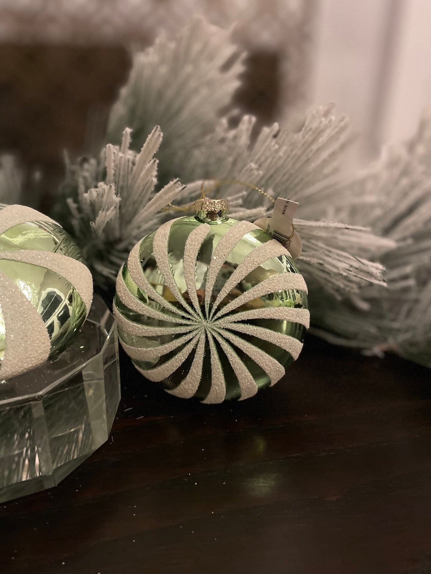 Set of 2. 4" glass peppermint candy disk ornament. Green and white.