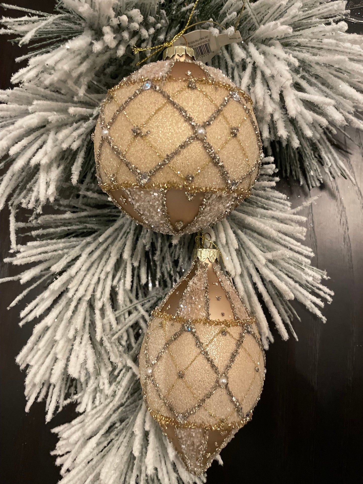 Set of 2. 4-6” glass jewel edge ball and finial ornaments. Ivory and gold.