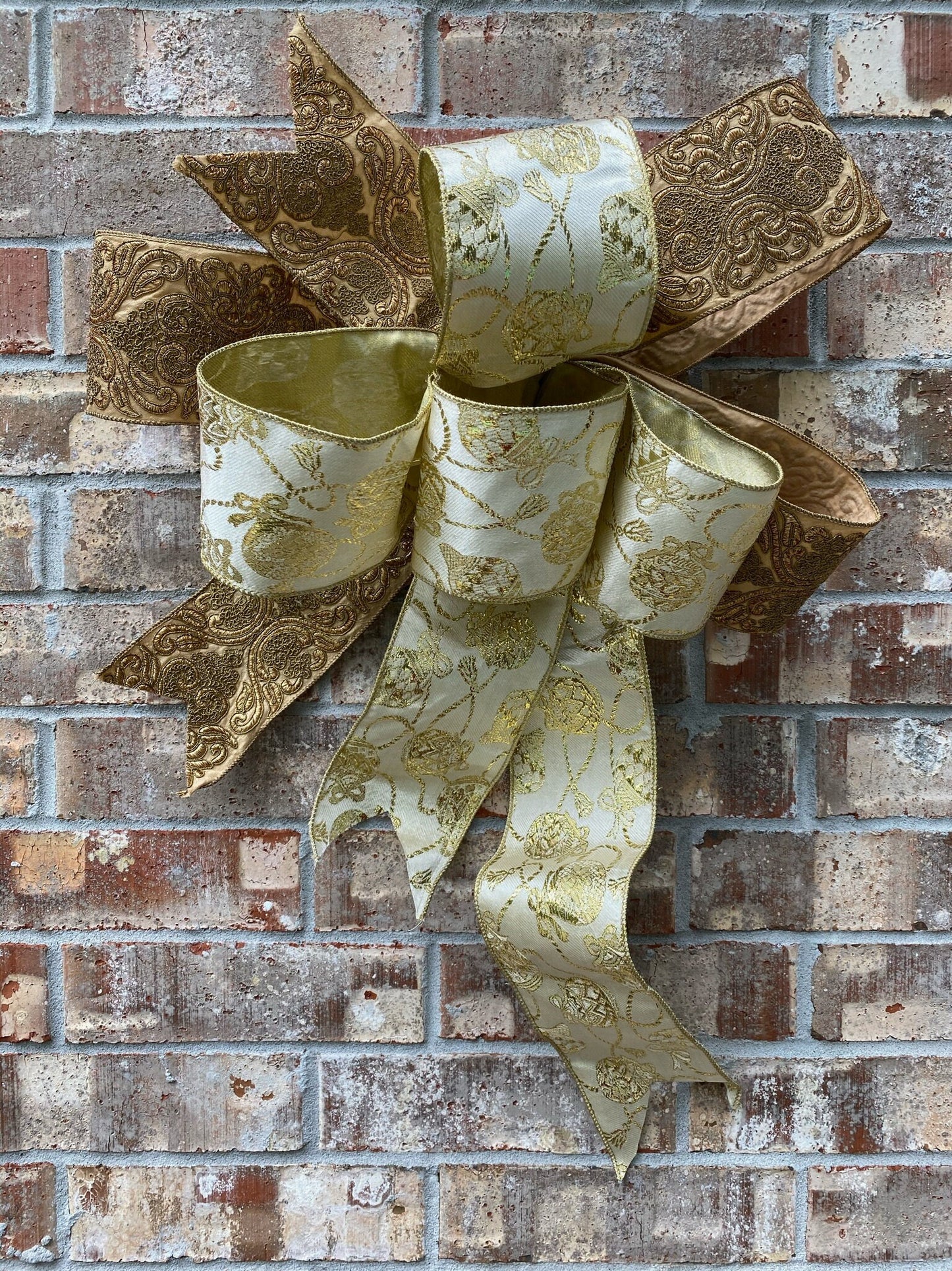 17”approx. diameter Bow antique gold and gold ribbon with 3 streamers the longest is 20” long from center of bow.