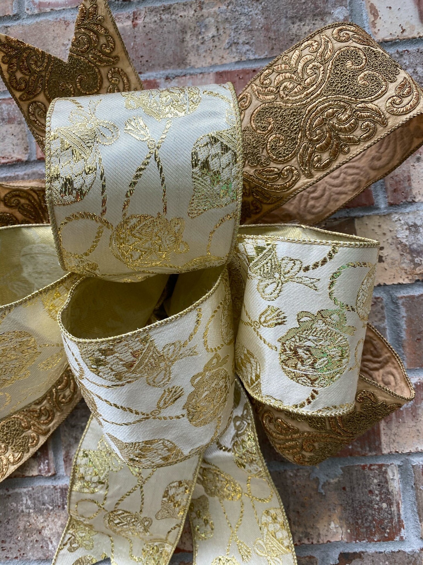 17”approx. diameter Bow antique gold and gold ribbon with 3 streamers the longest is 20” long from center of bow.