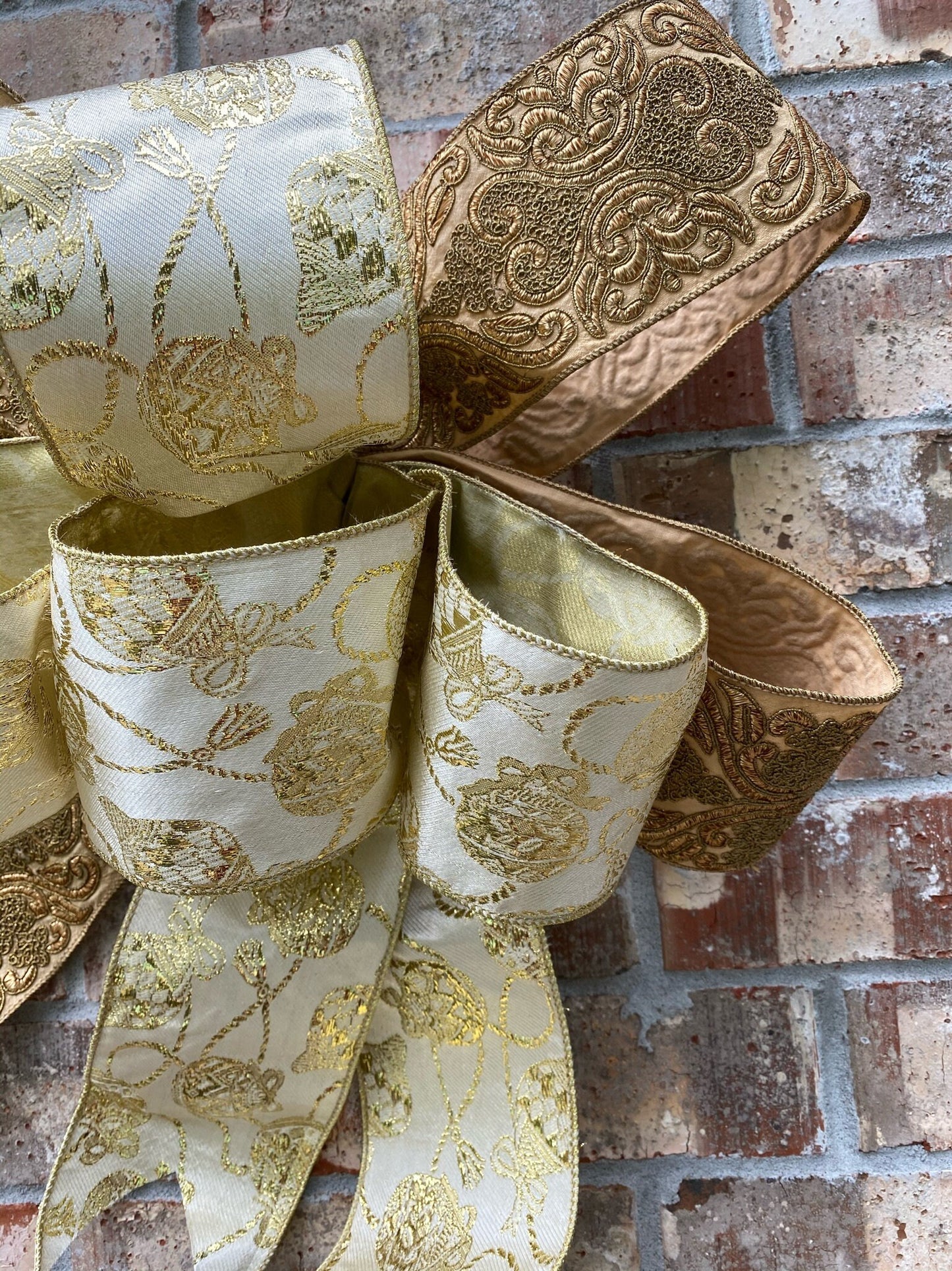 17”approx. diameter Bow antique gold and gold ribbon with 3 streamers the longest is 20” long from center of bow.