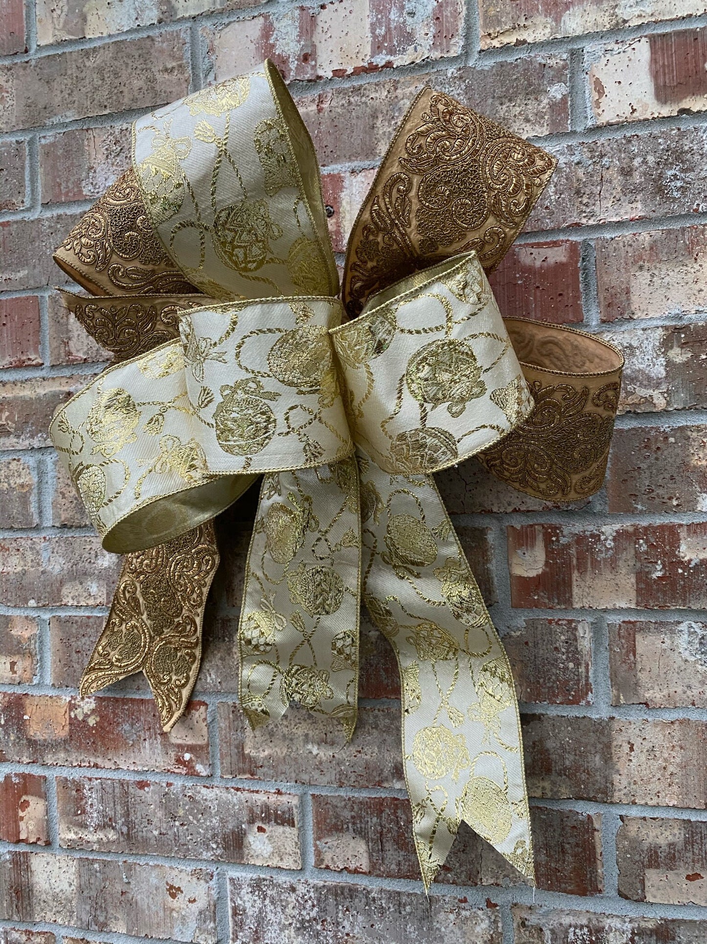 17”approx. diameter Bow antique gold and gold ribbon with 3 streamers the longest is 15” long from center of bow.