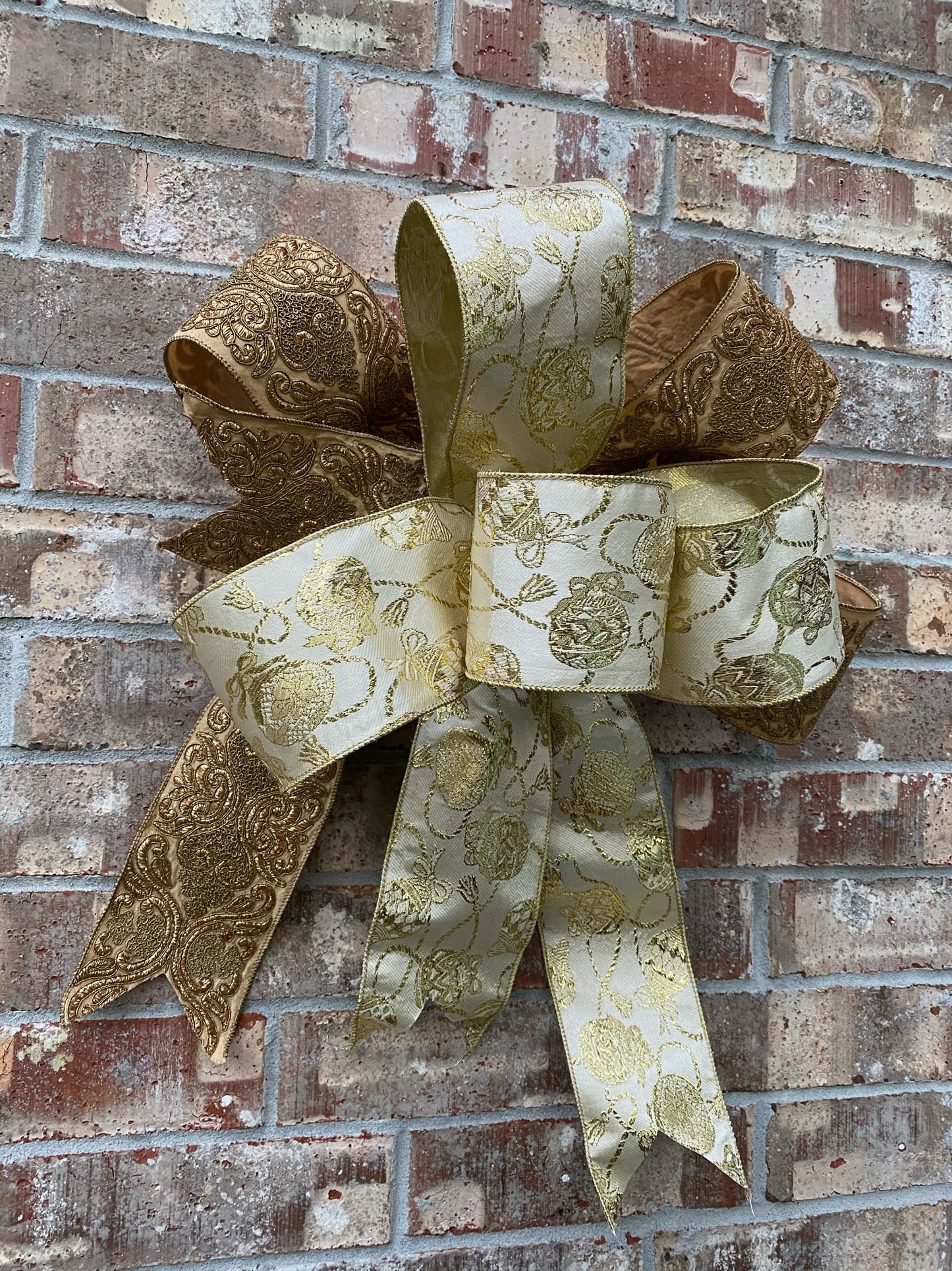 17”approx. diameter Bow antique gold and gold ribbon with 3 streamers the longest is 15” long from center of bow.