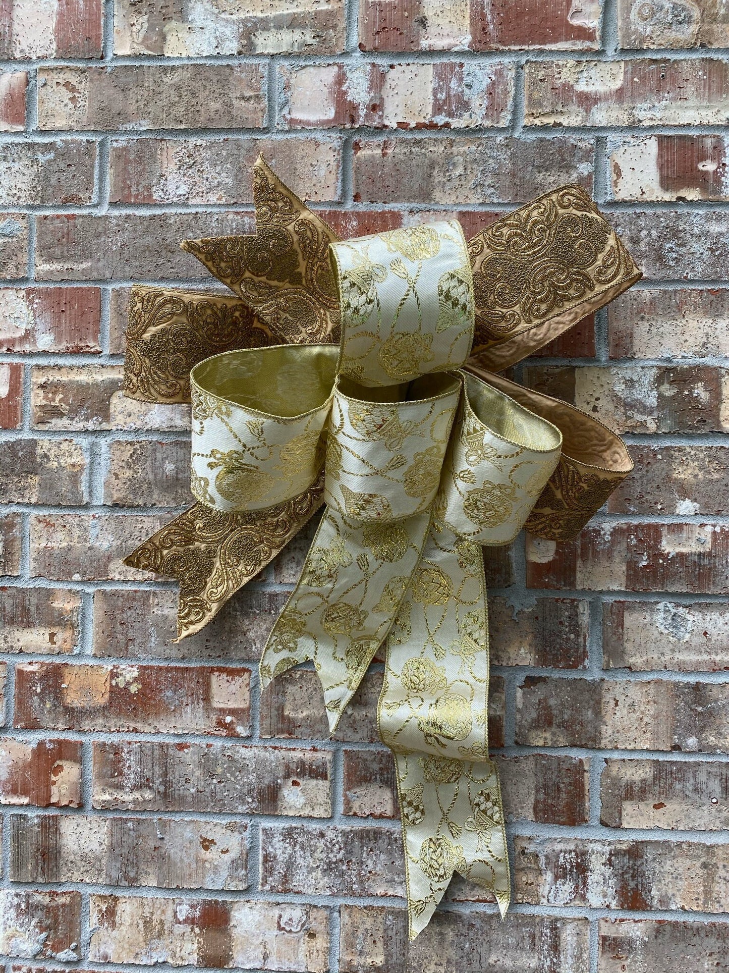 17”approx. diameter Bow antique gold and gold ribbon with 3 streamers the longest is 20” long from center of bow.