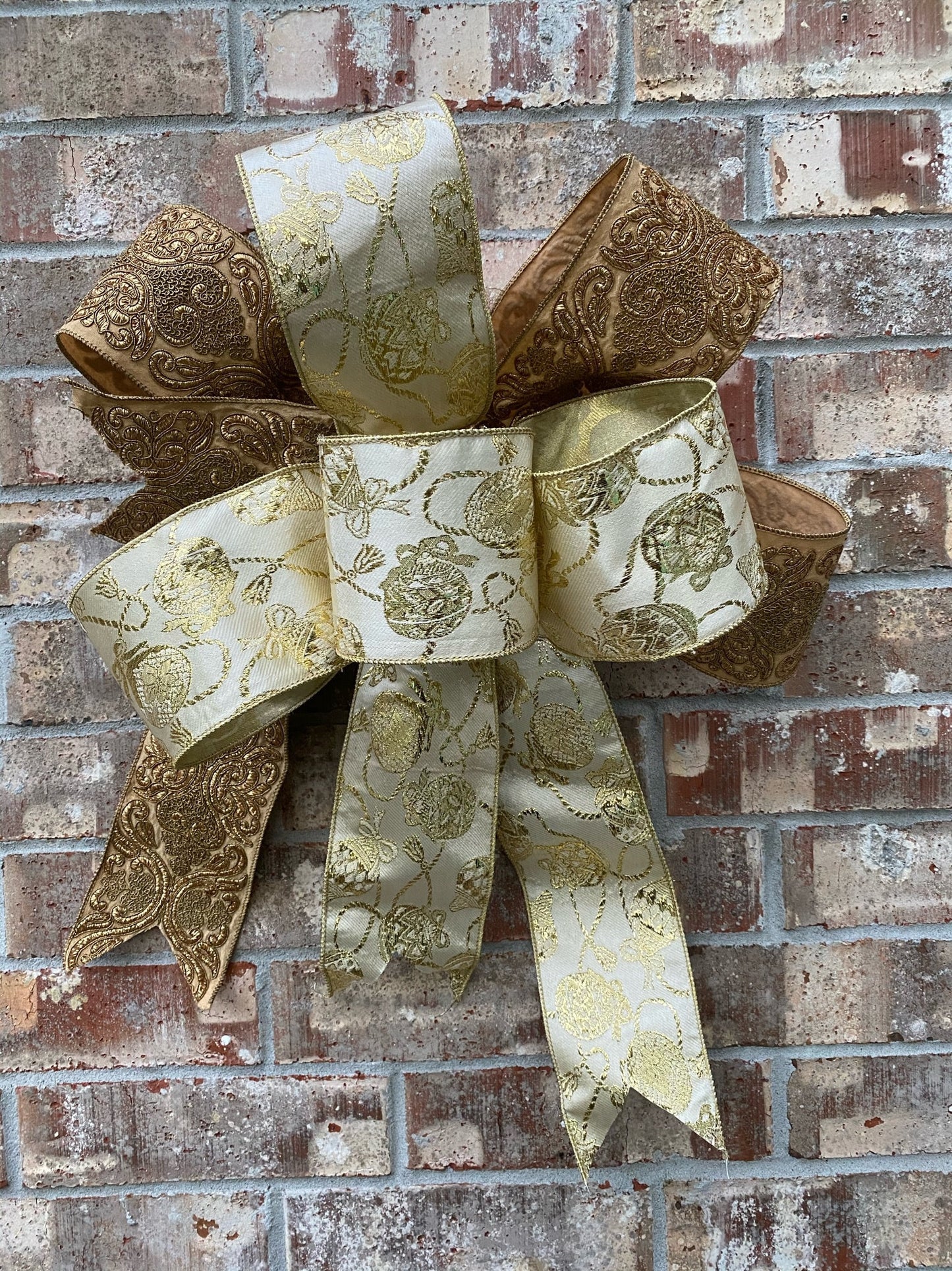 17”approx. diameter Bow antique gold and gold ribbon with 3 streamers the longest is 15” long from center of bow.