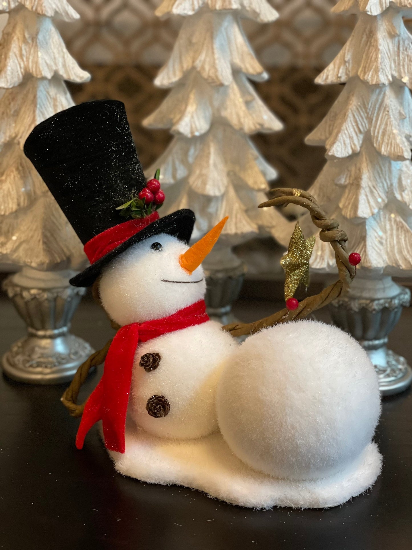 9.75” frosted snowman laying with star tabletop ornament