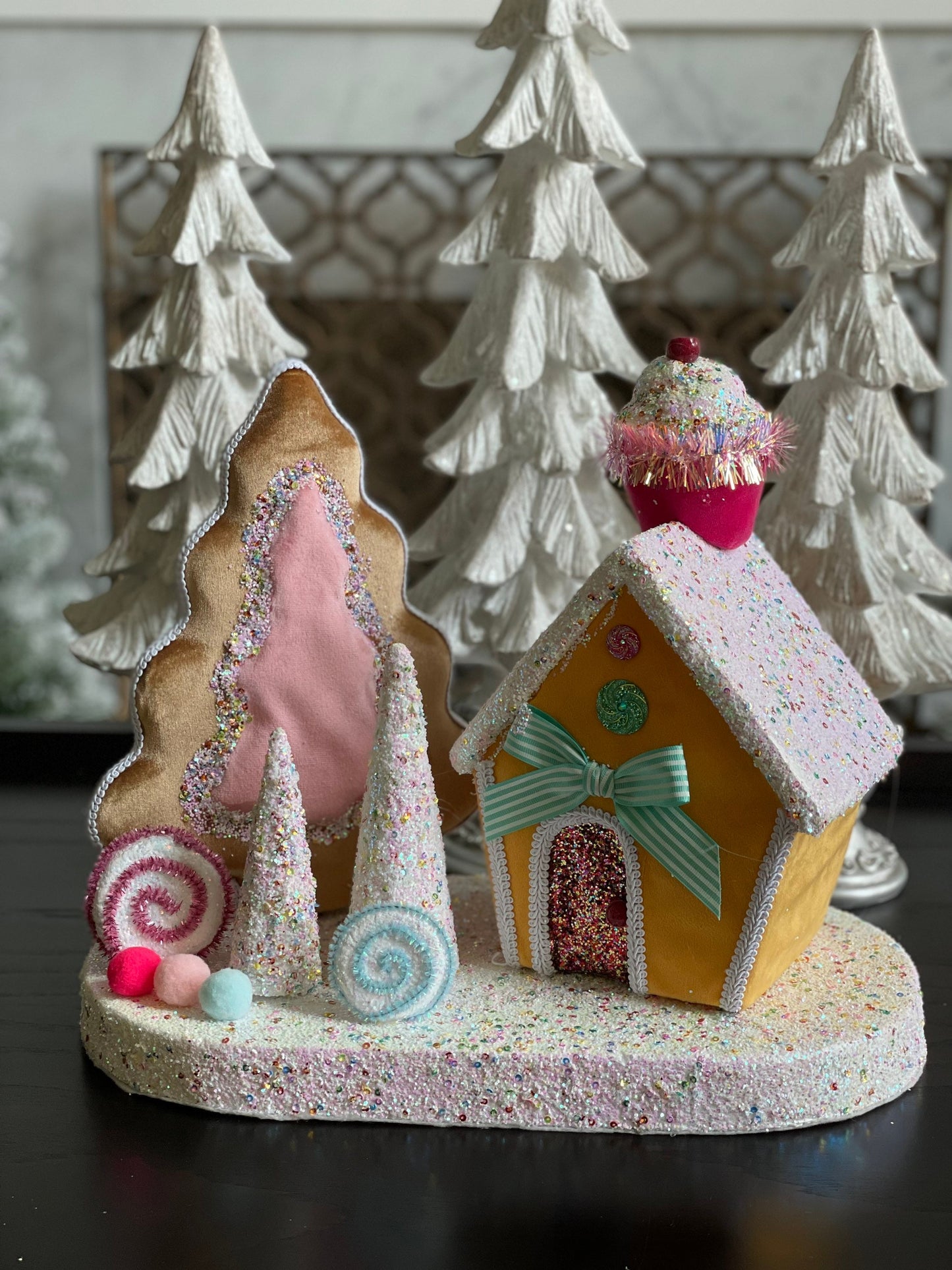14”Hx 16”W. Candy house with cupcake, candy and trees. One Candy house.