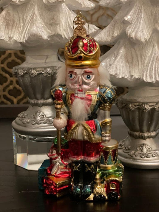 8.5" Nutcracker with presents ornament. With crown or hat. Glass. Raz. Only one nutcracker.