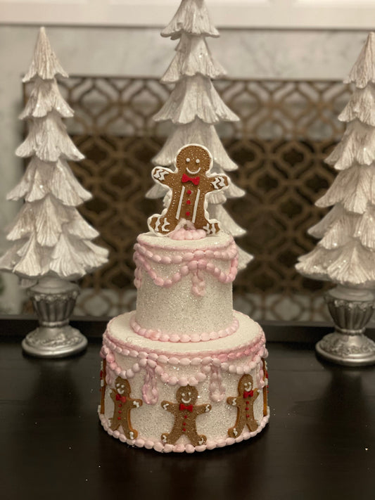 14”h x 8”w gingerbread Christmas icing pink cake.