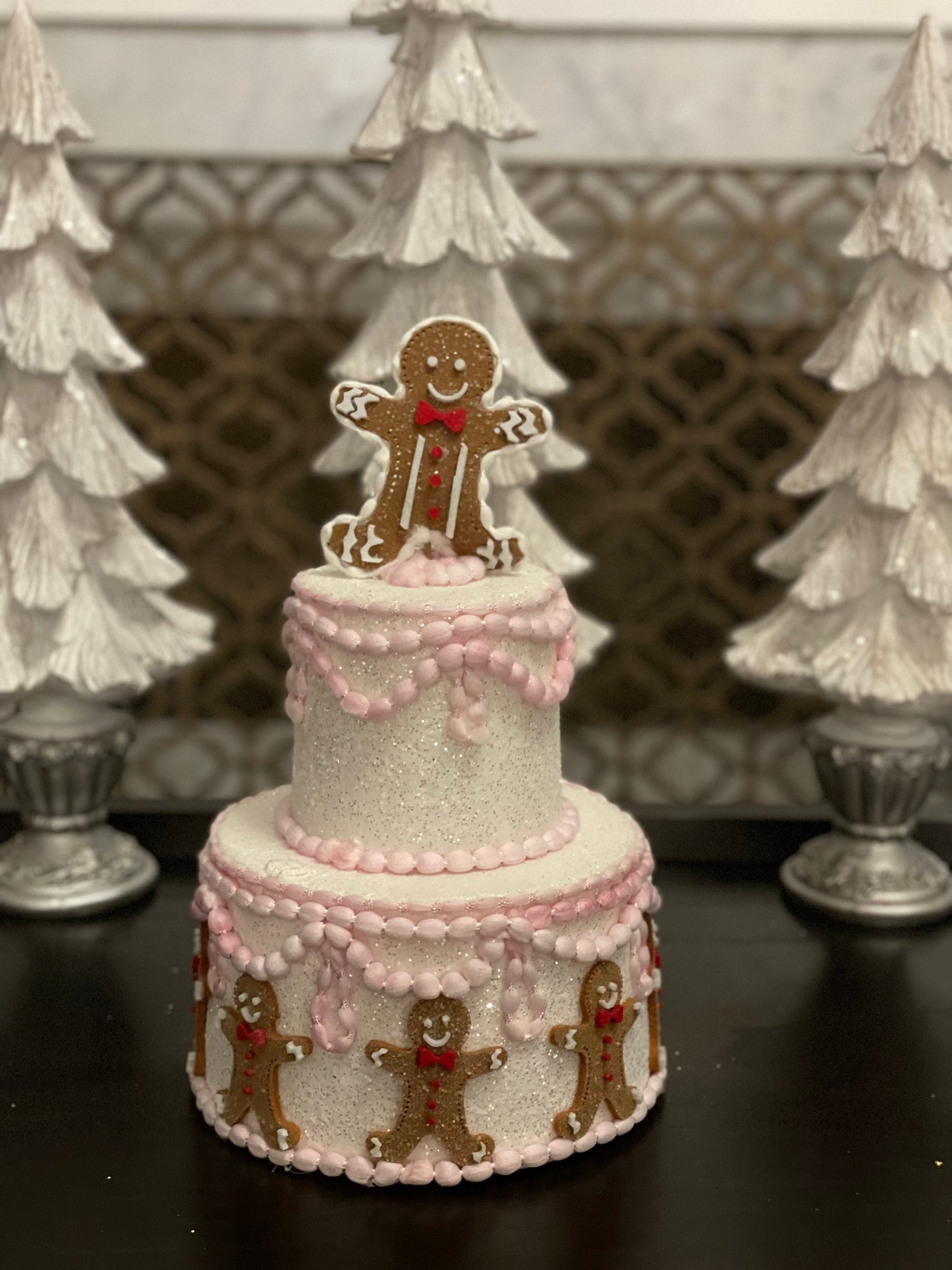 14”h x 8”w gingerbread Christmas icing pink cake.