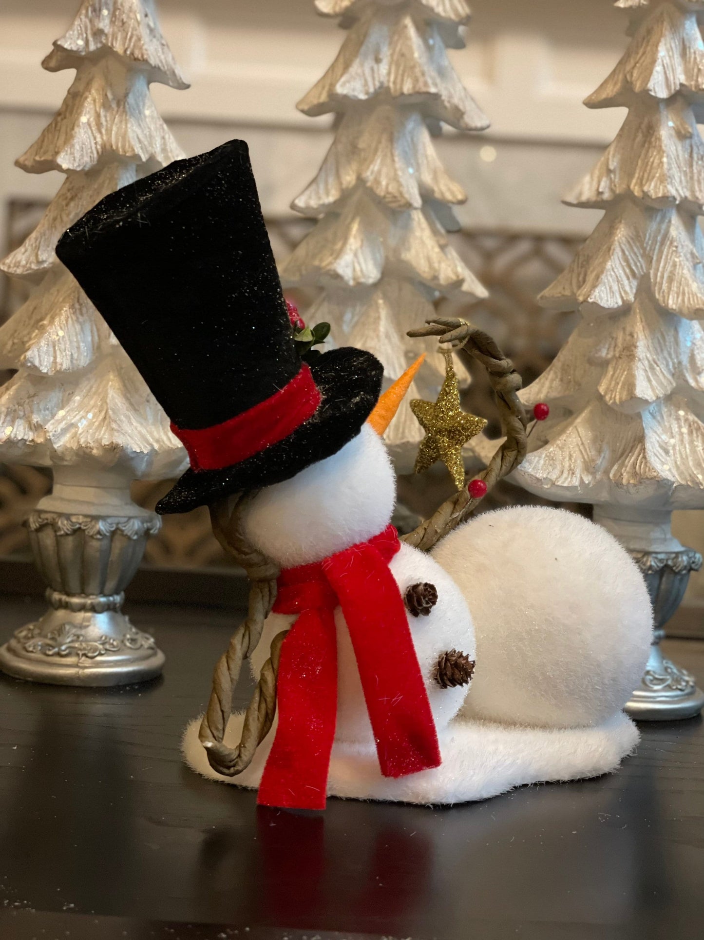 9.75” frosted snowman laying with star tabletop ornament