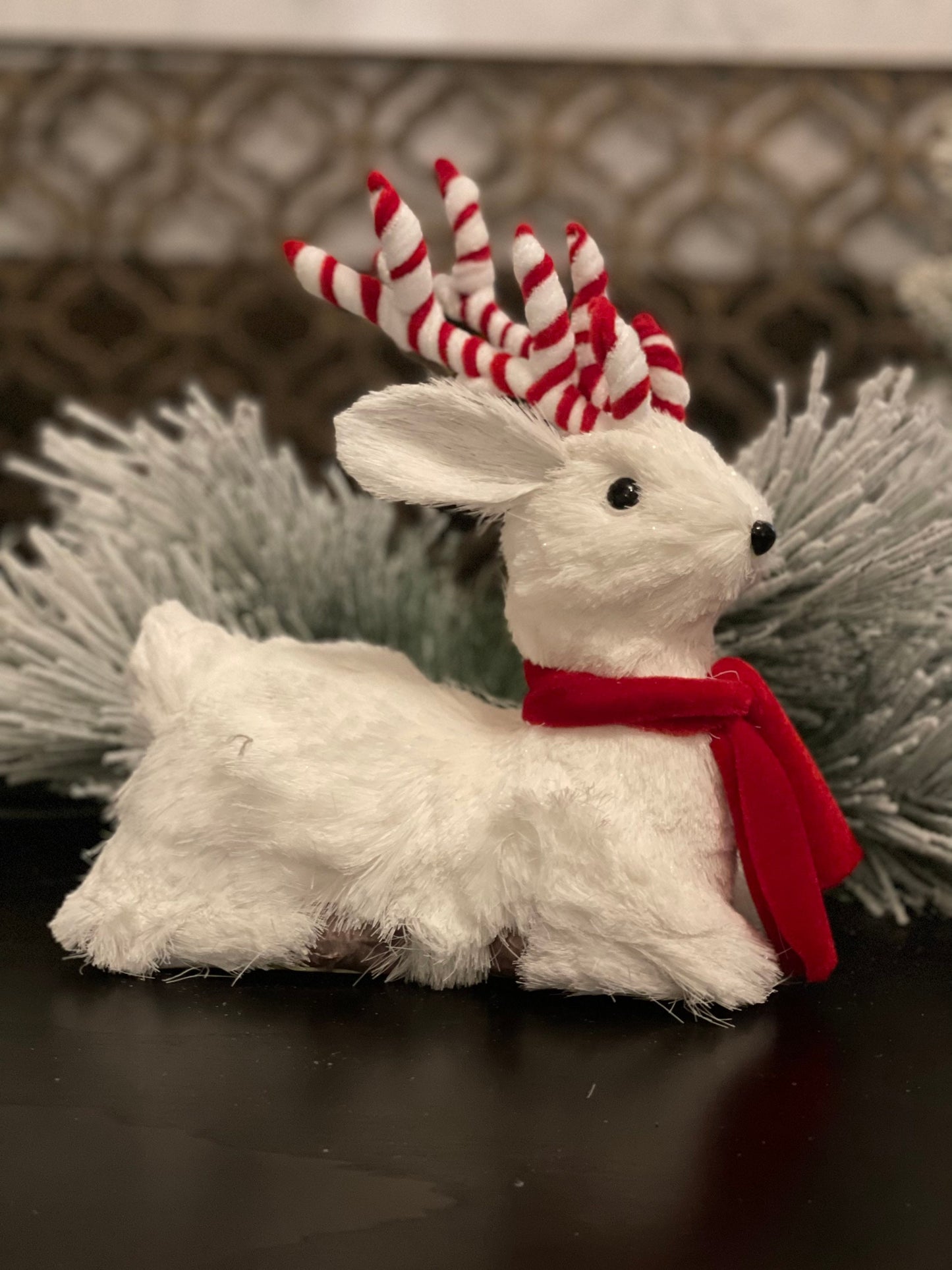 10.75 inch Deer sitting tabletop ornament. Christmas. White and red.