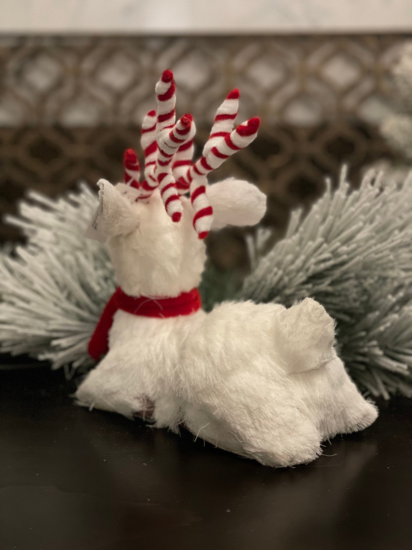 10.75 inch Deer sitting tabletop ornament. Christmas. White and red.