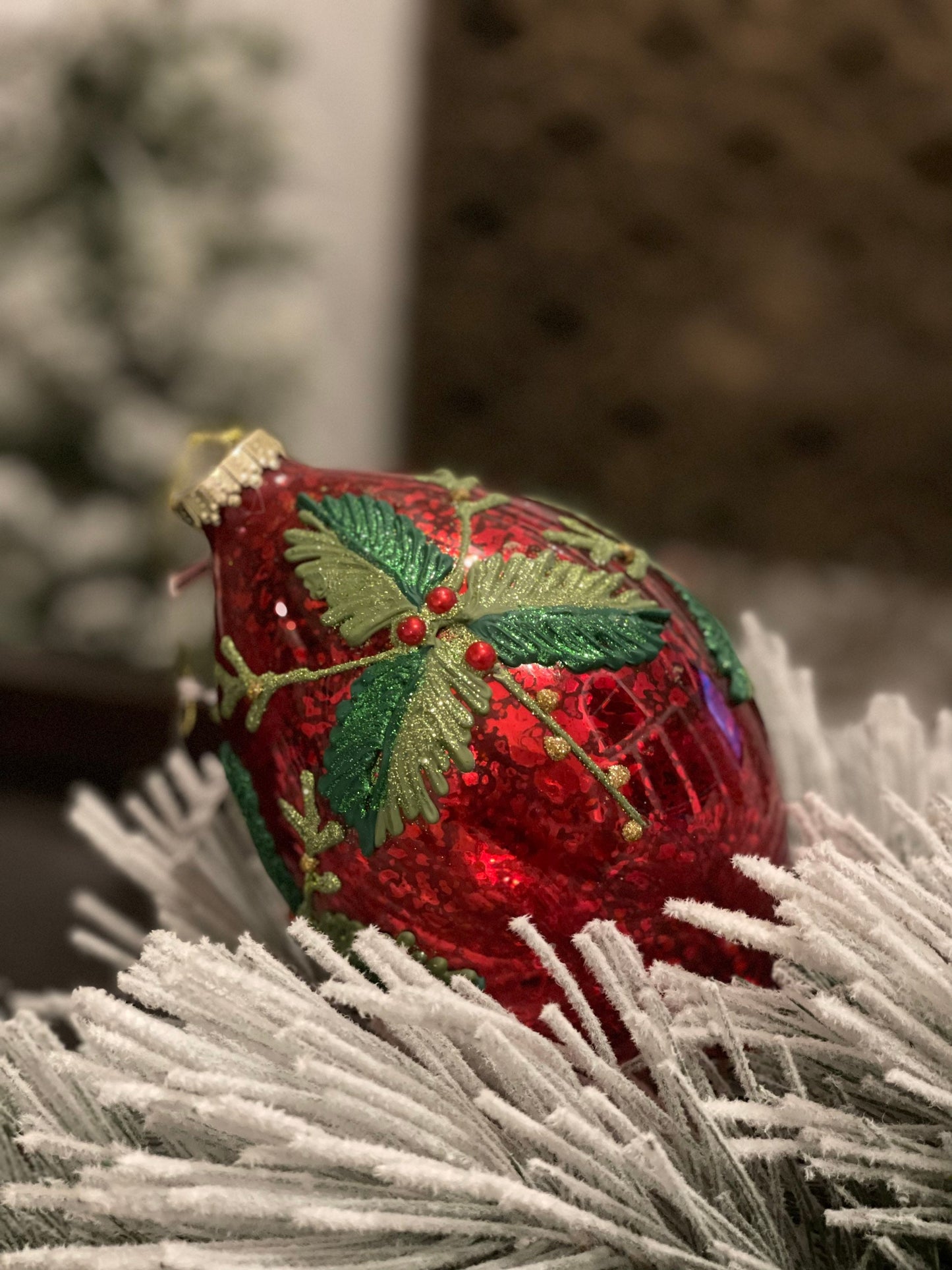 7" Holly patterned glass ornament.