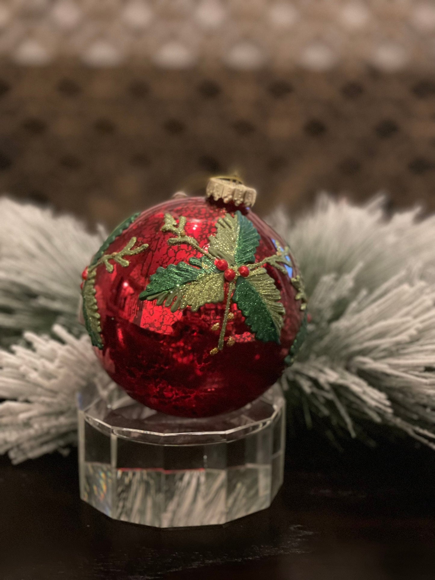 7" Holly patterned glass ornament.