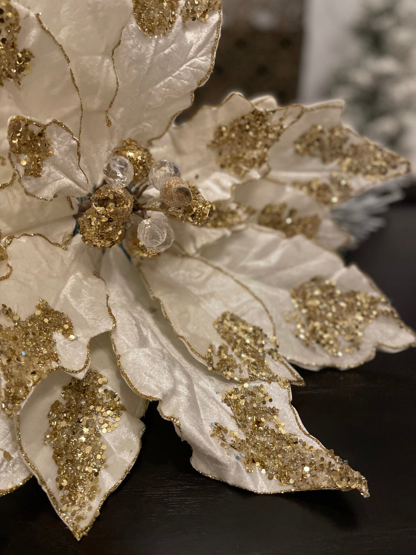 21”Extra large velvet Poinsettia with stem light ivory and gold. Sequins and glitter. Poinsettia measures 21” tip to tip. Stem is 14.5”.