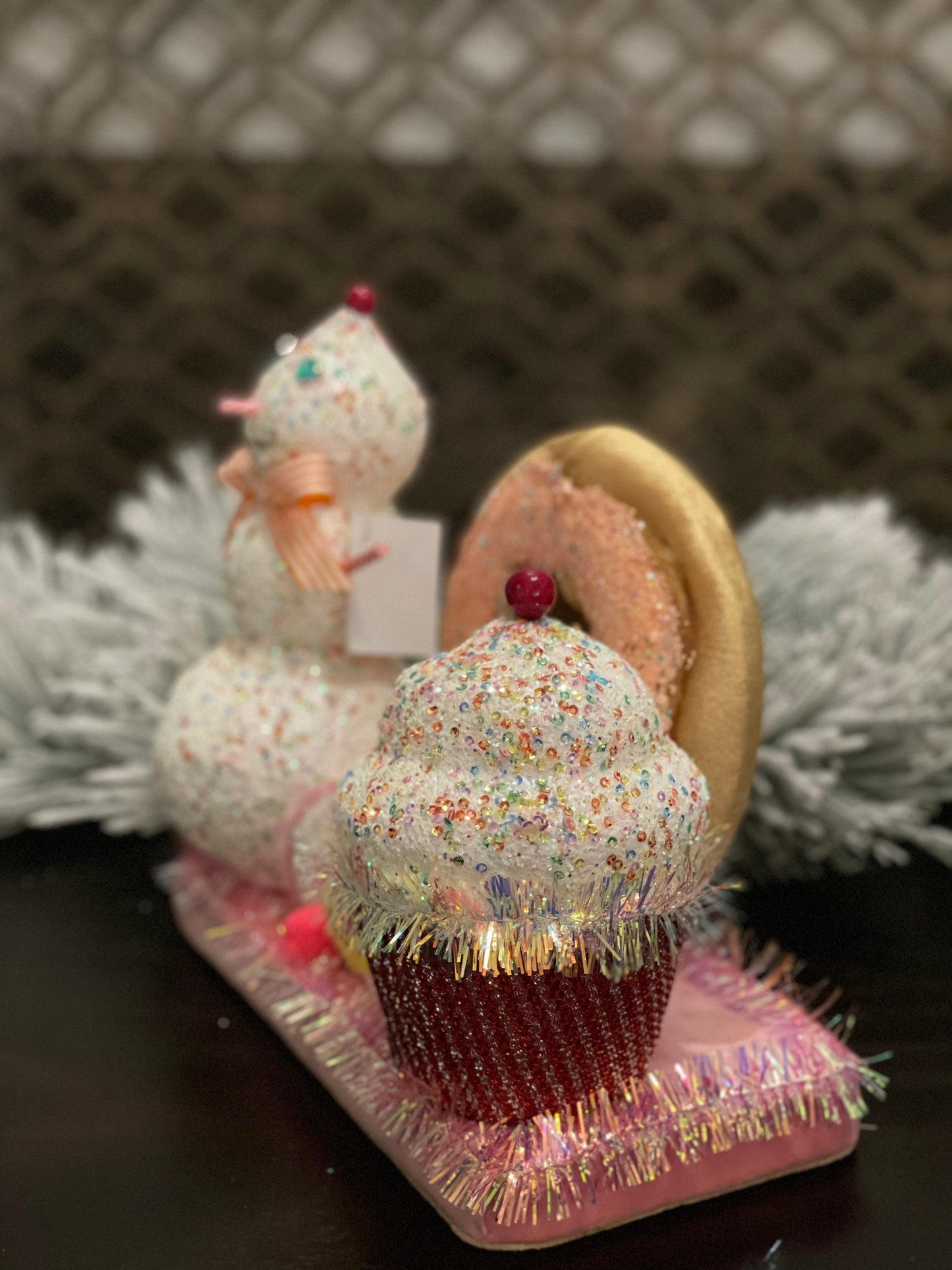 11” l x 10”h x 5.5” w. Snowman donut and cupcake scene.