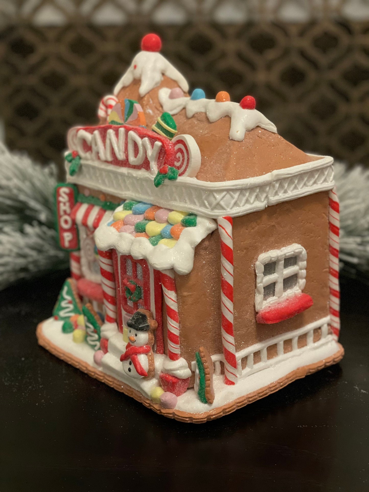 11”H x 10” L x 8”W. Candy Gingerbread store with snowman lighted.