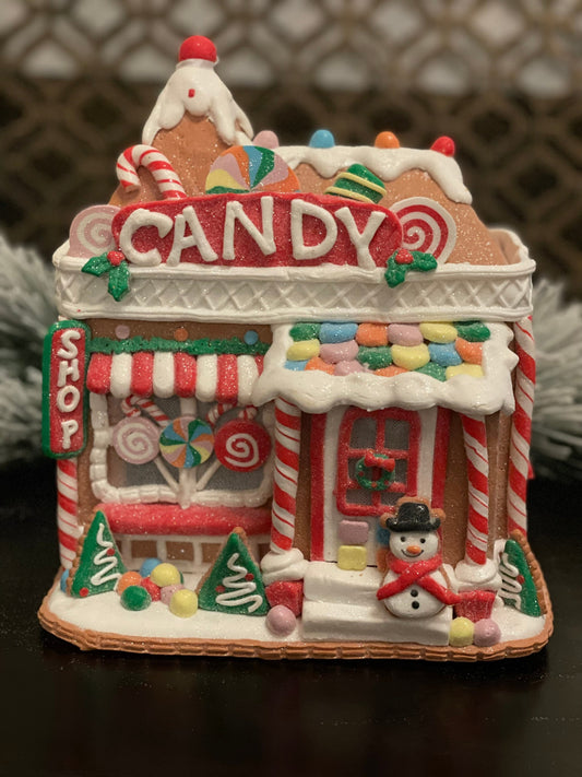 11”H x 10” L x 8”W. Candy Gingerbread store with snowman lighted.
