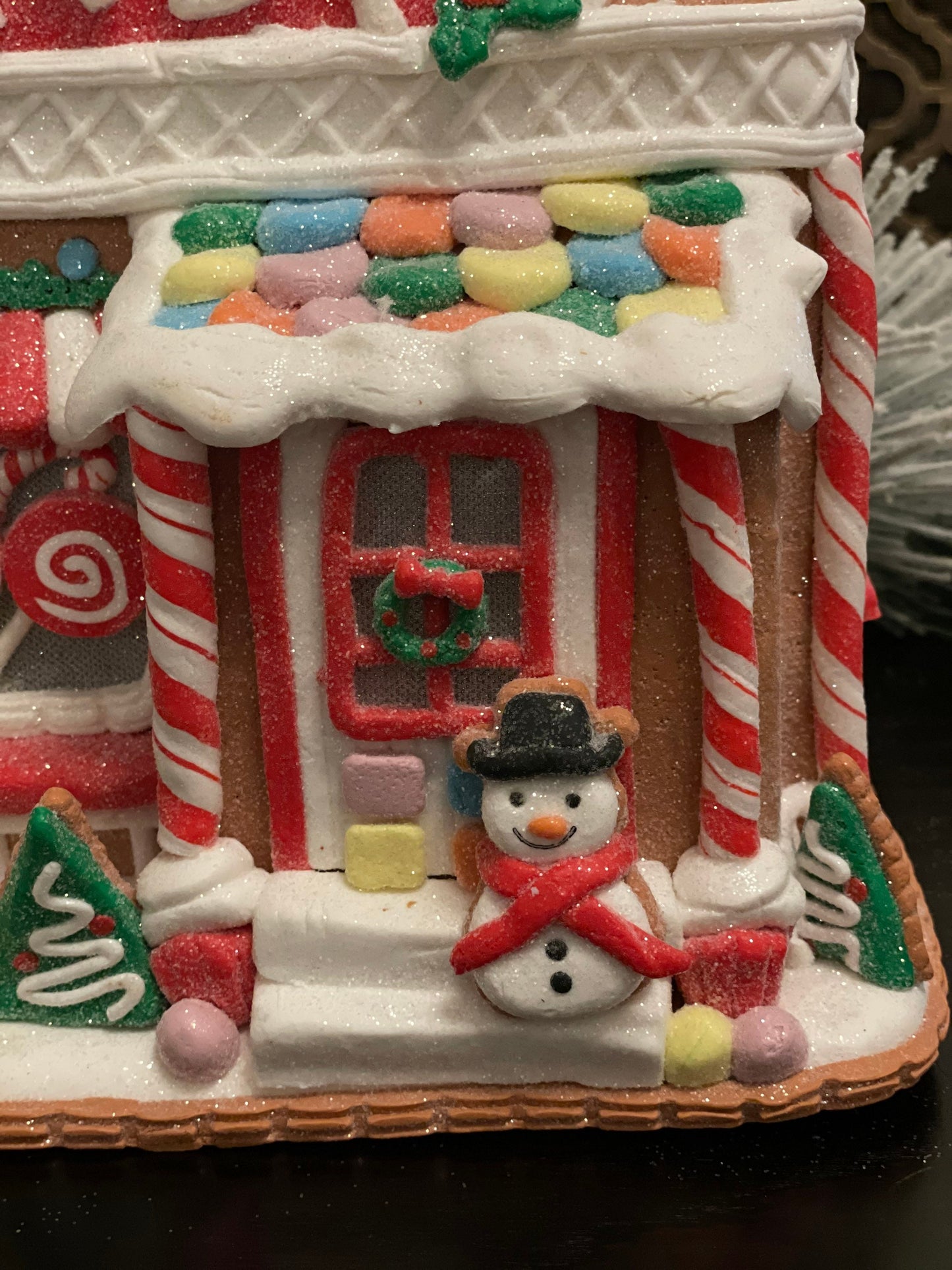 11”H x 10” L x 8”W. Candy Gingerbread store with snowman lighted.