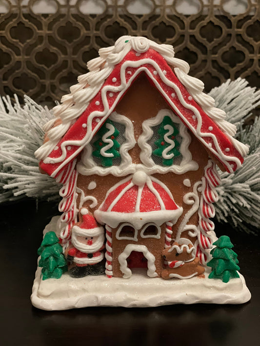 8.5”H x 7”W. Santa Gingerbread lighted house. Red, green and white.