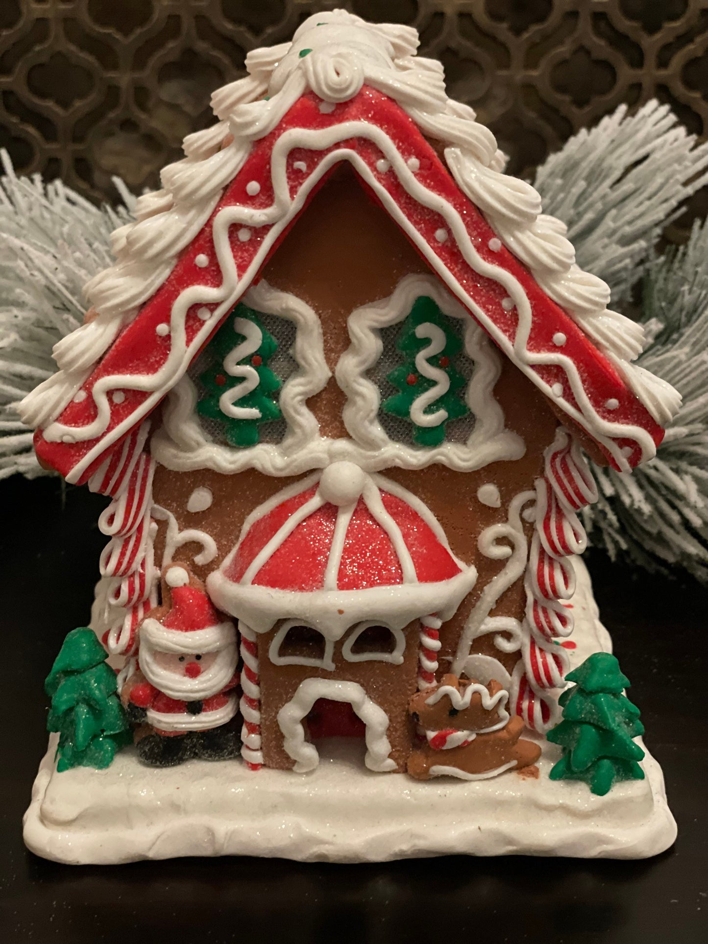 8.5”H x 7”W. Santa Gingerbread lighted house. Red, green and white.