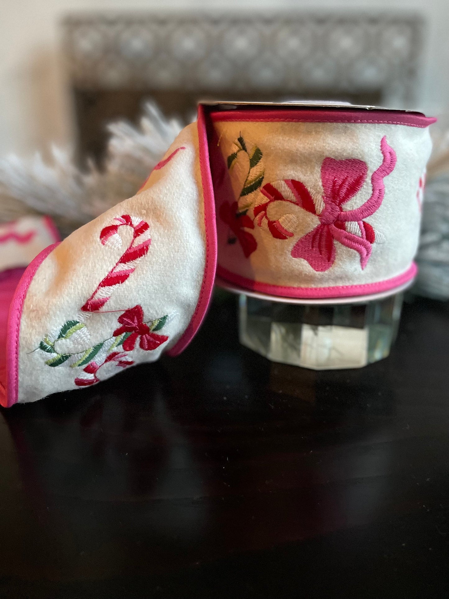 4” x 5 yds. Designer candy cane and bow embroidered wool felt ribbon. Pink and cream. Wired. Regency.
