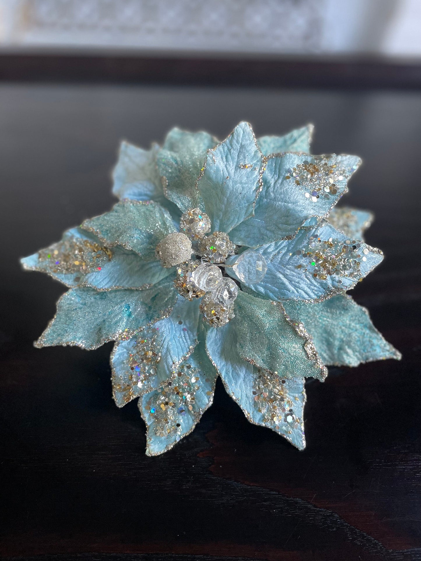 9.5” Poinsettia with clip soft blue, glitter and beaded 9.5” tip to tip.