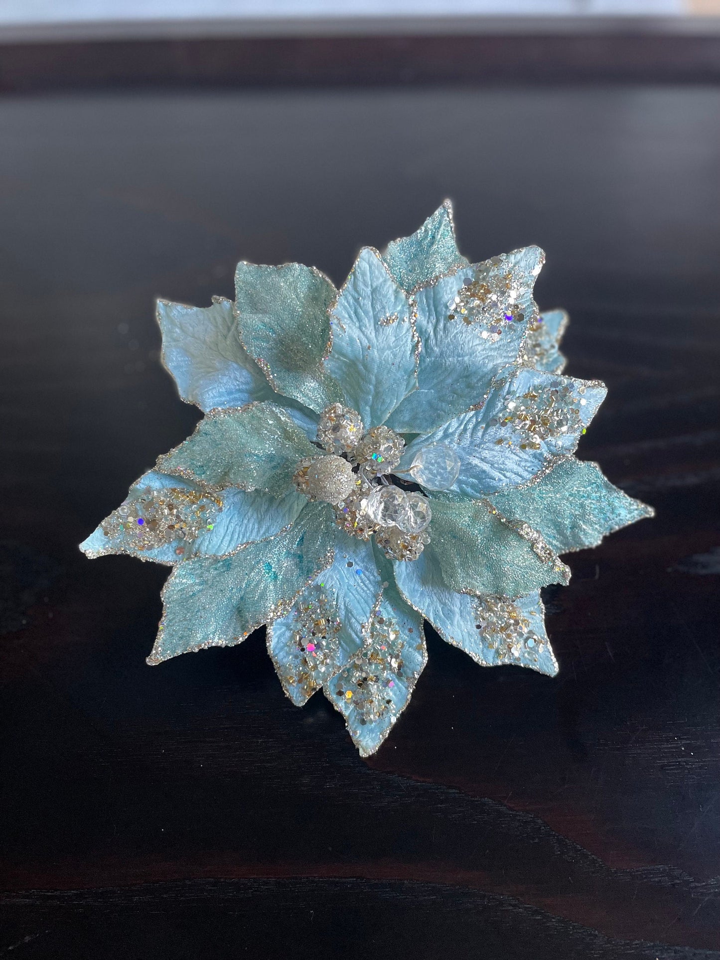 9.5” Poinsettia with clip soft blue, glitter and beaded 9.5” tip to tip.