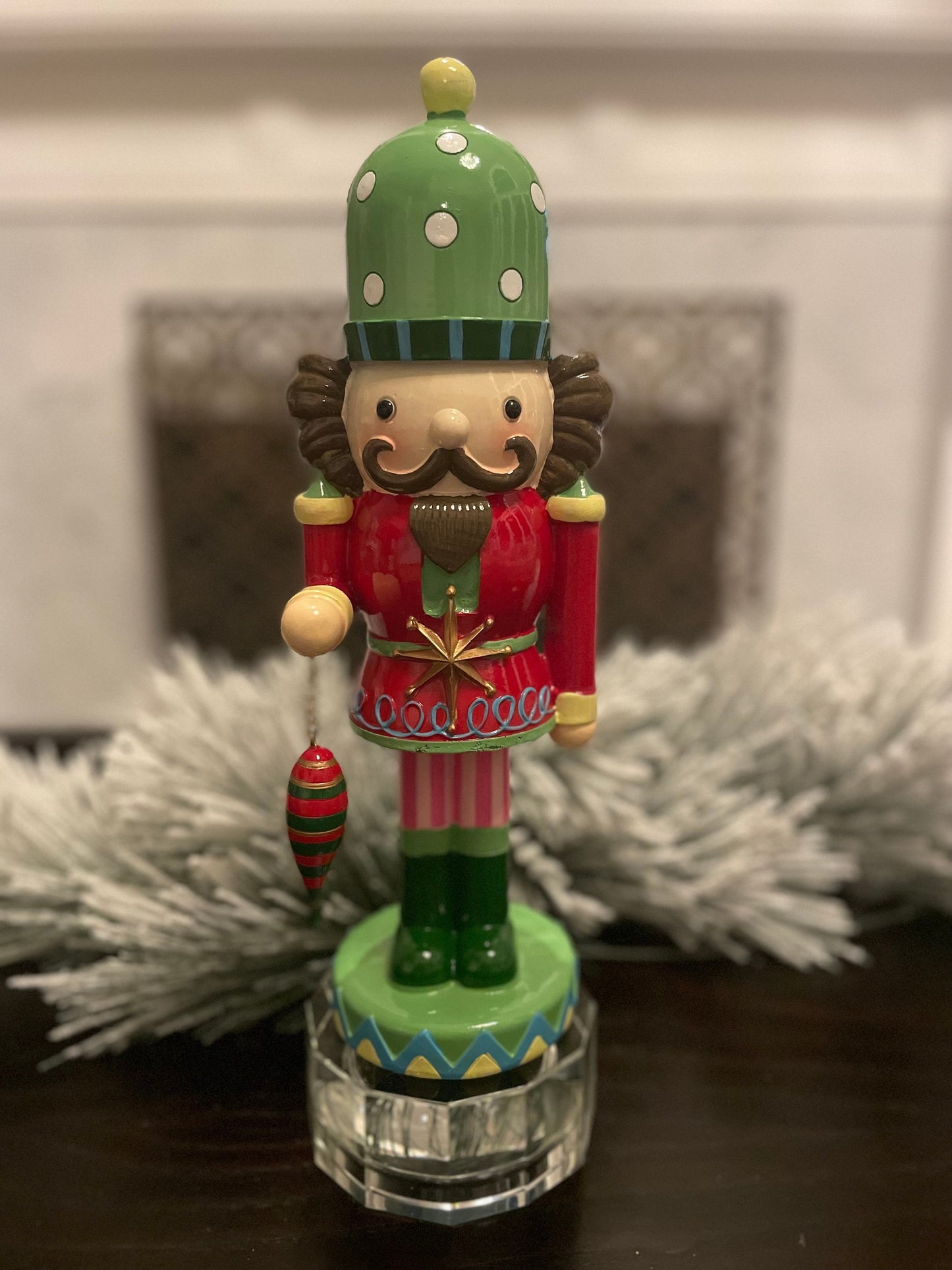 14” Resin nutcracker with ornament. Tabletop.