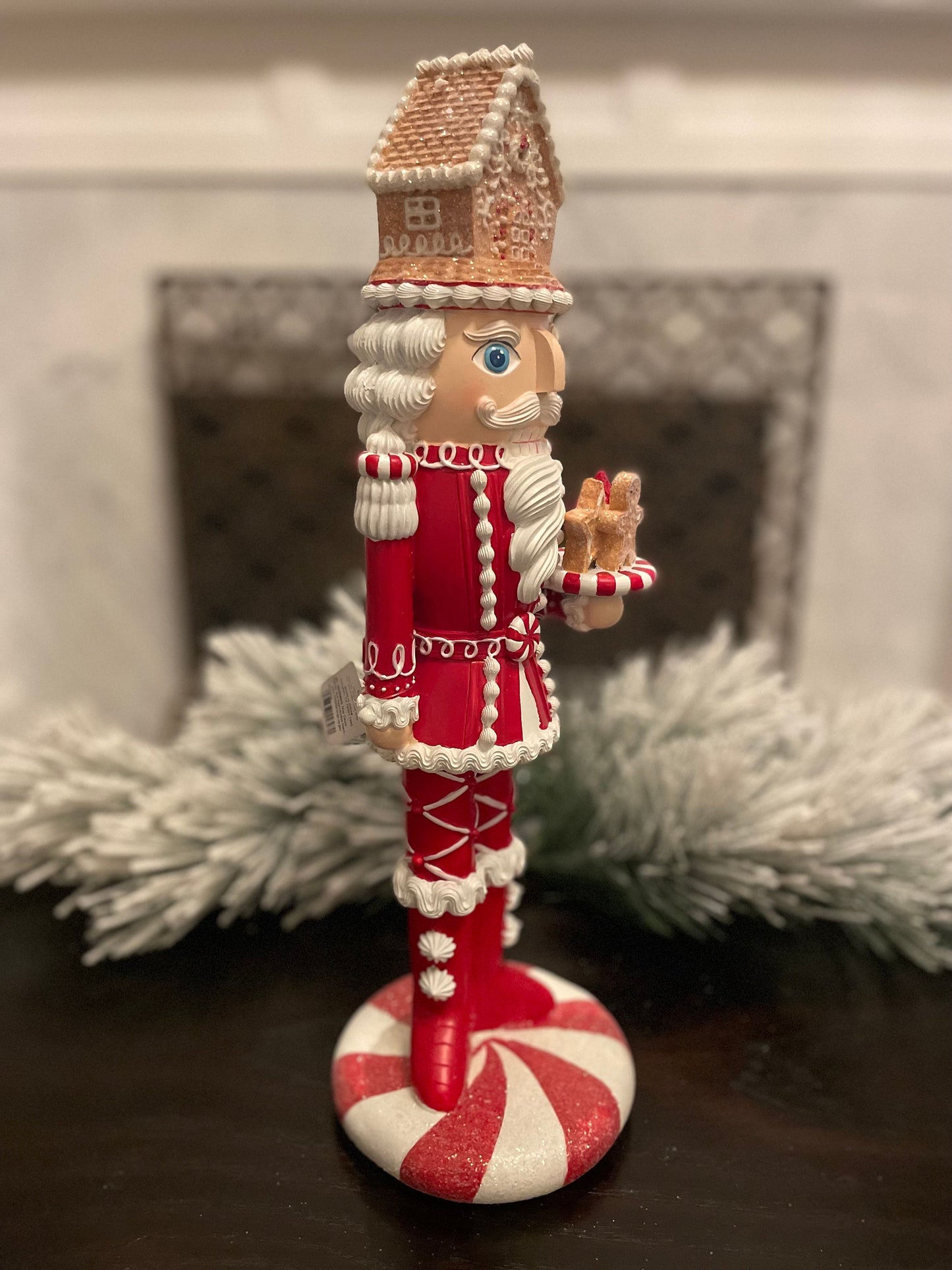 17.5” Nutcracker with gingerbread house, resin peppermint red and white. Sweet nutcracker!