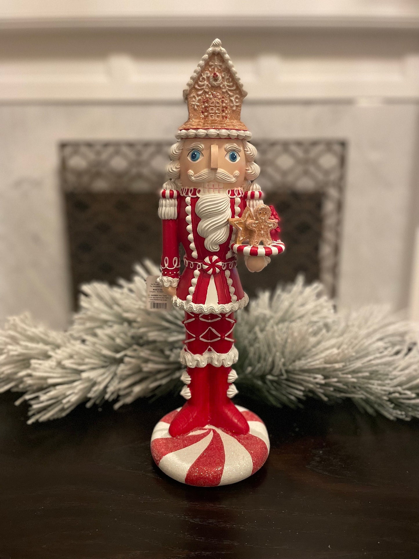 17.5” Nutcracker with gingerbread house, resin peppermint red and white. Sweet nutcracker!