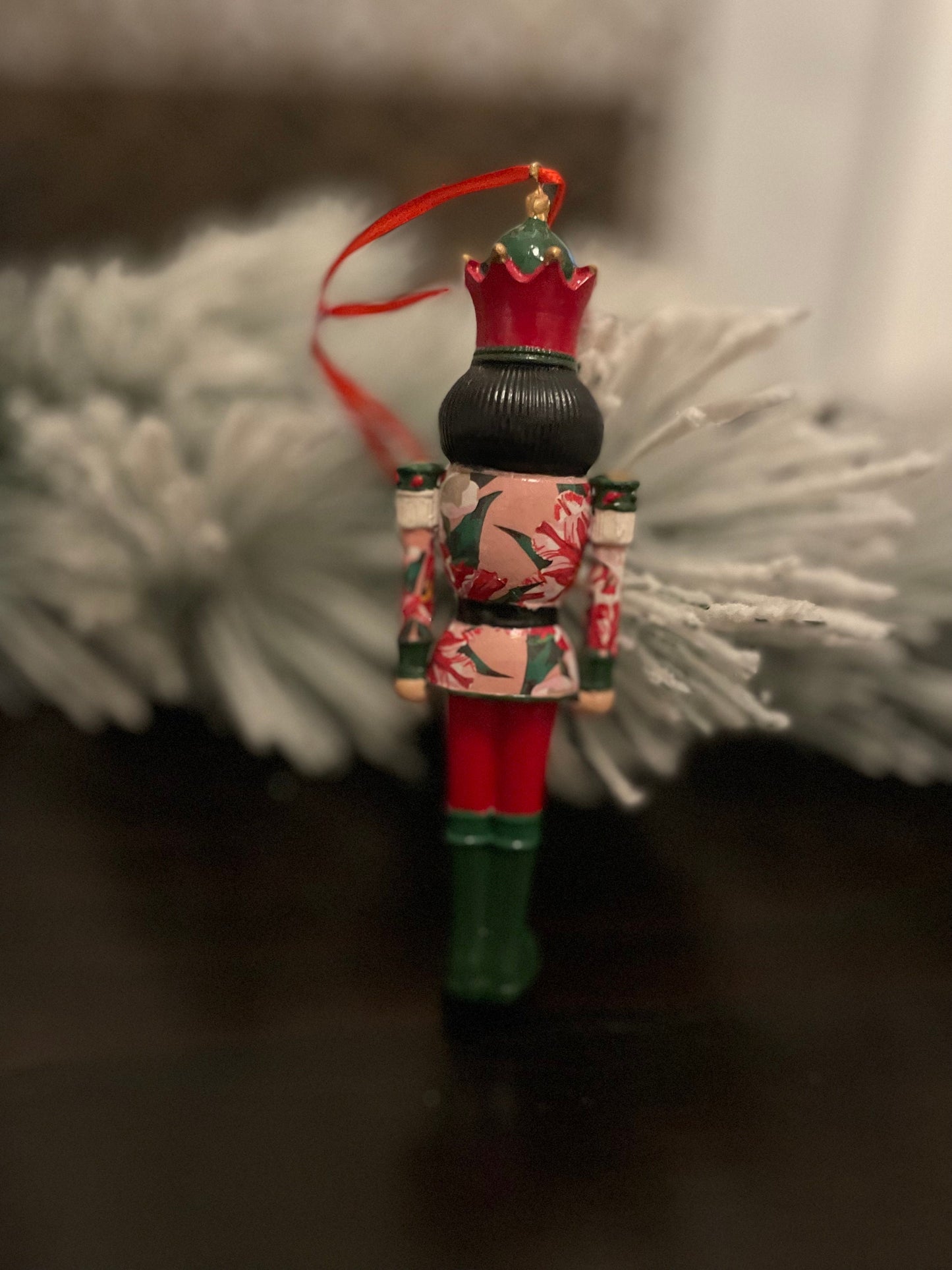 6” Poinsettia nutcracker ornament. Resin.