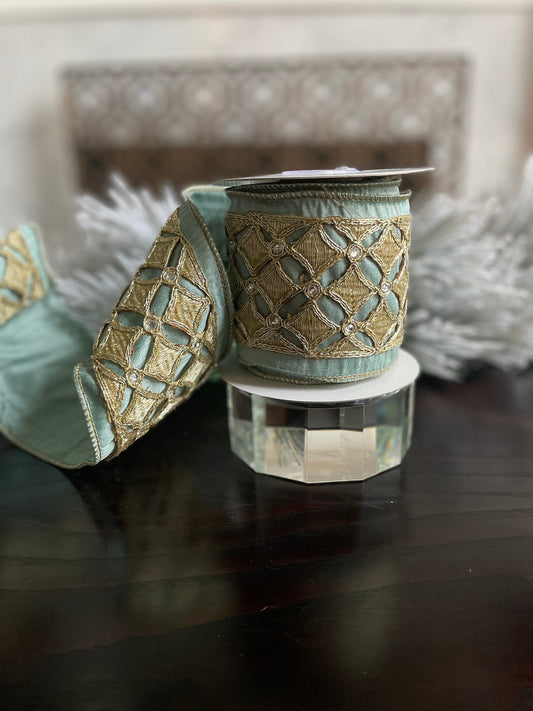 4” x 5 yds. Designer aqua and platinum jeweled diamond dupion ribbon. Aqua and platinum ribbon. Wired. Regency.
