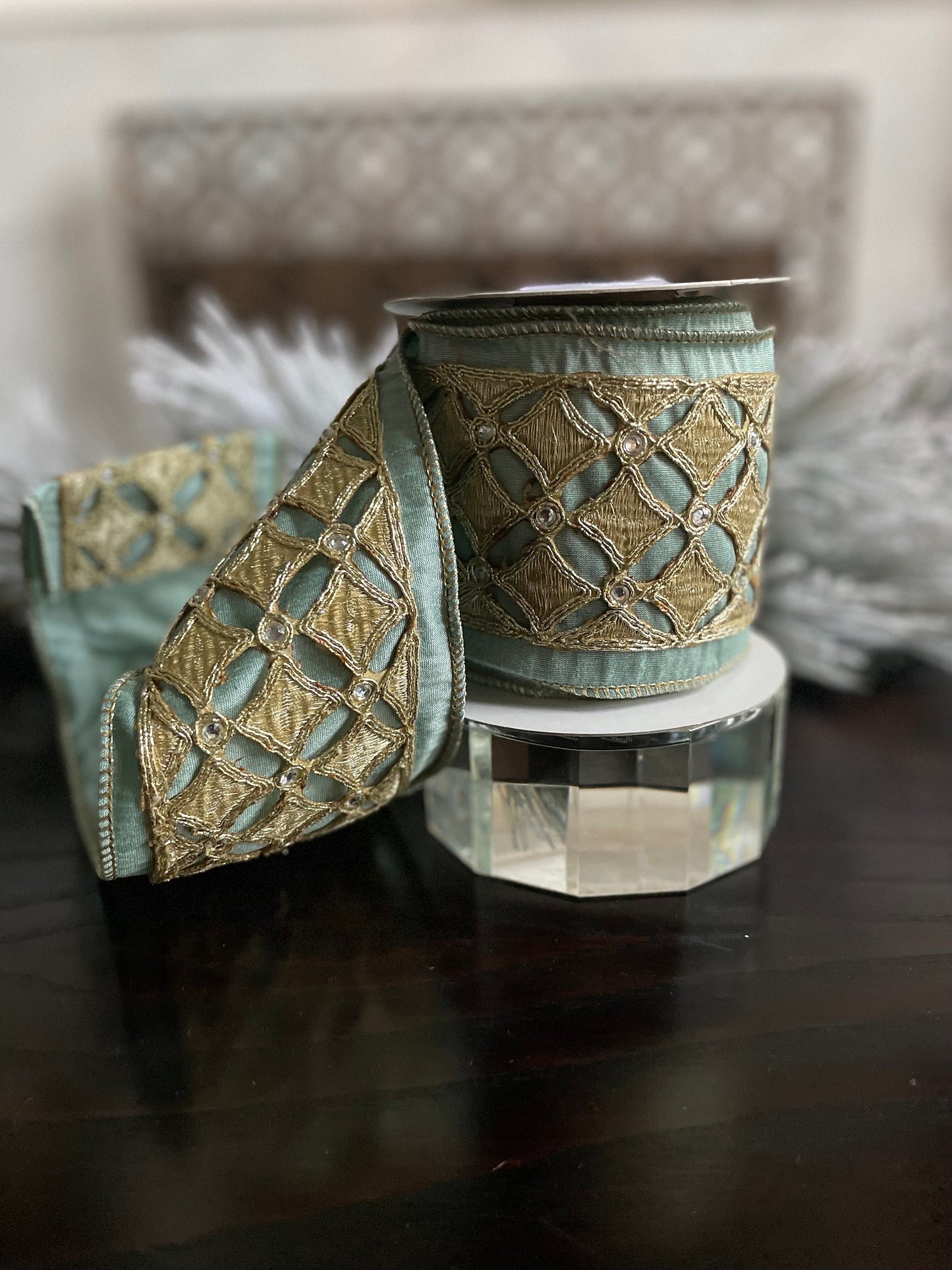 4” x 5 yds. Designer aqua and platinum jeweled diamond dupion ribbon. Aqua and platinum ribbon. Wired. Regency.