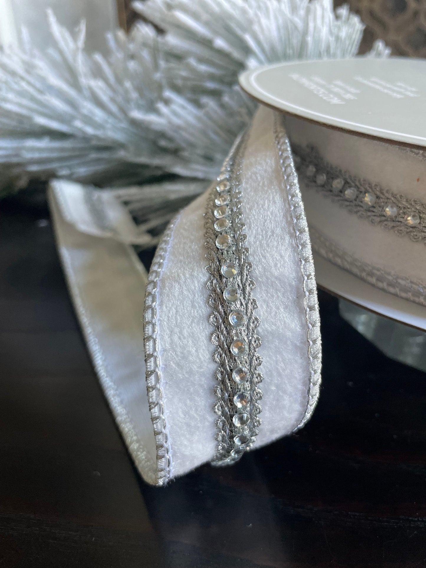 1.5” x 10 yds. Designer jeweled white velvet wired ribbon. Raz.