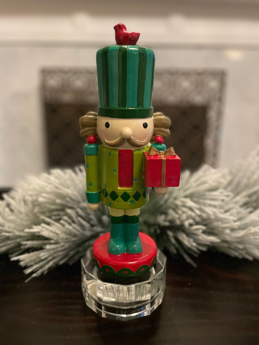 Nutcracker. 12” resin nutcracker with packages. Multi color.