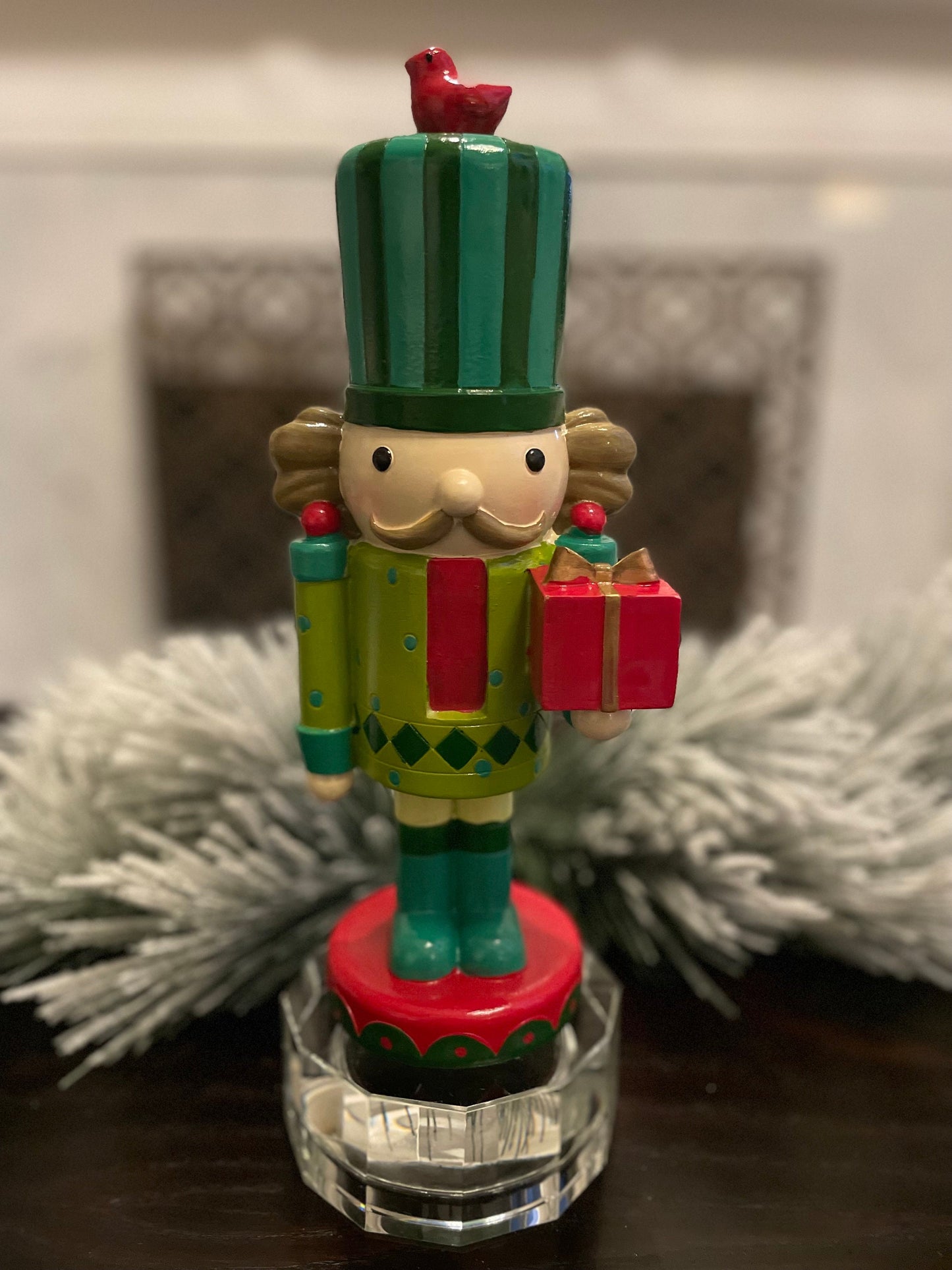 Nutcracker. 12” resin nutcracker with packages. Multi color.